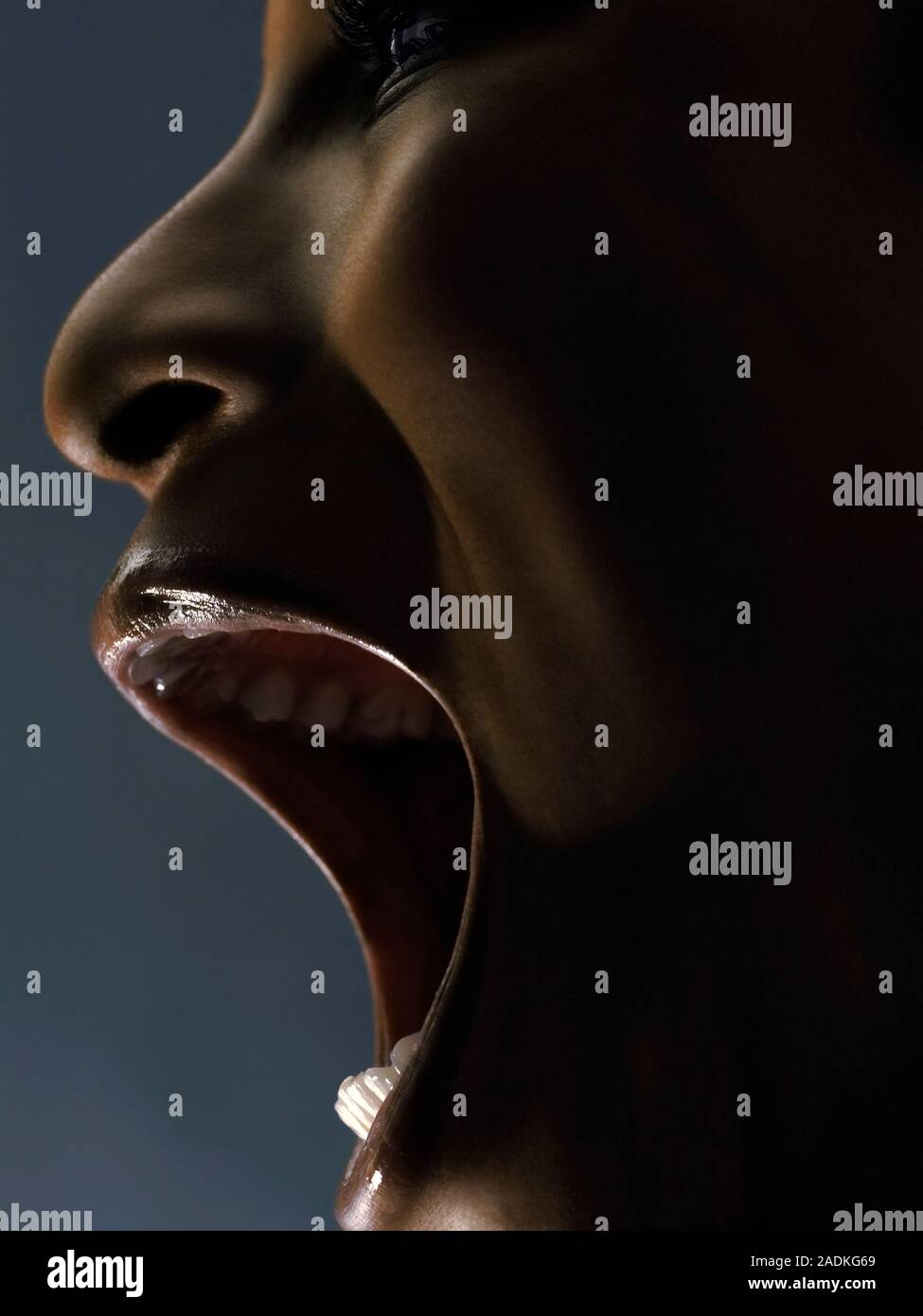 MODEL RELEASED. Facial exercise. Woman opening her mouth wide Stock ...