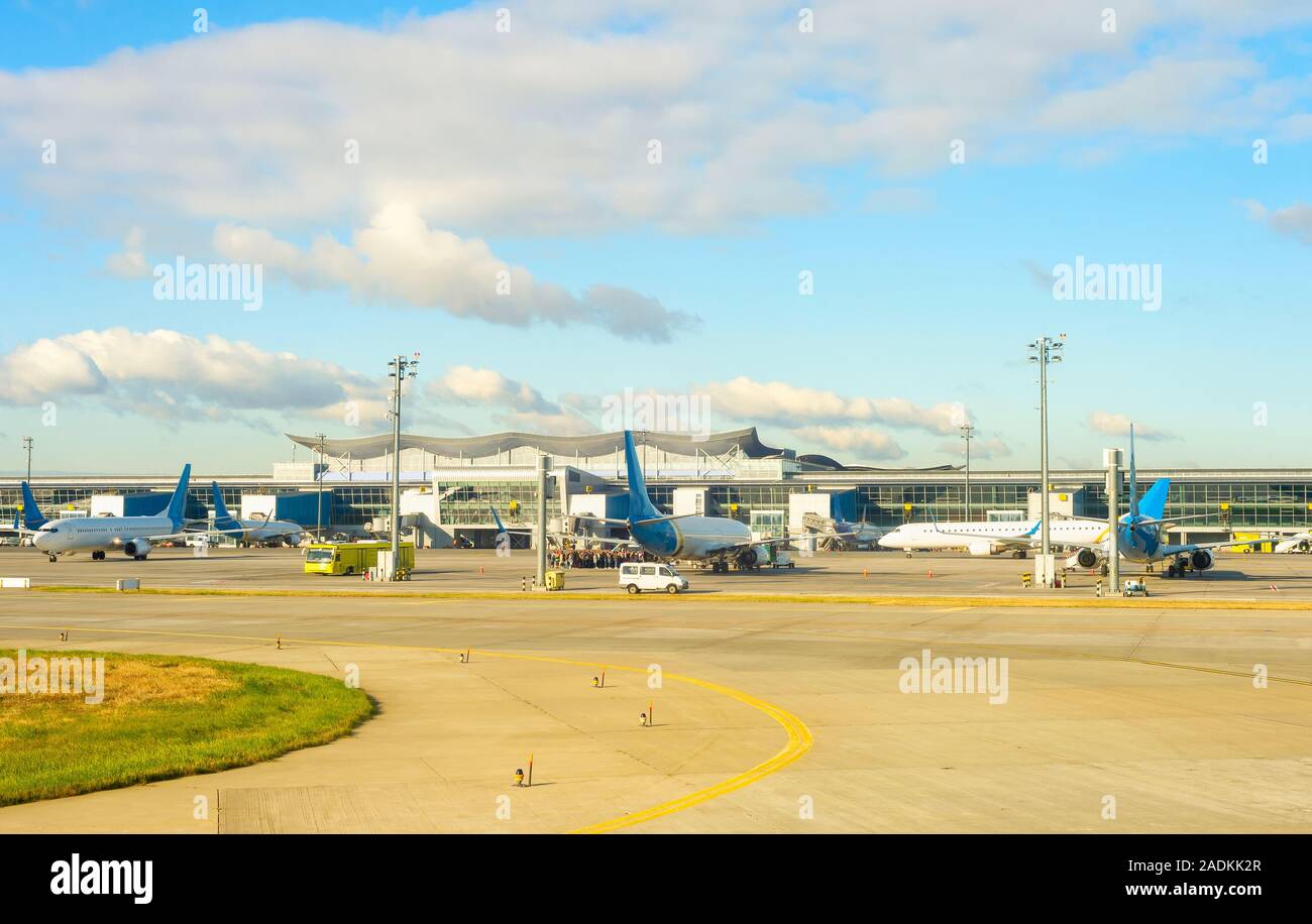 Boryspil airport scene, airplanes, bus and passengers queue at airfield. Kyiv, Ukraine Stock Photo