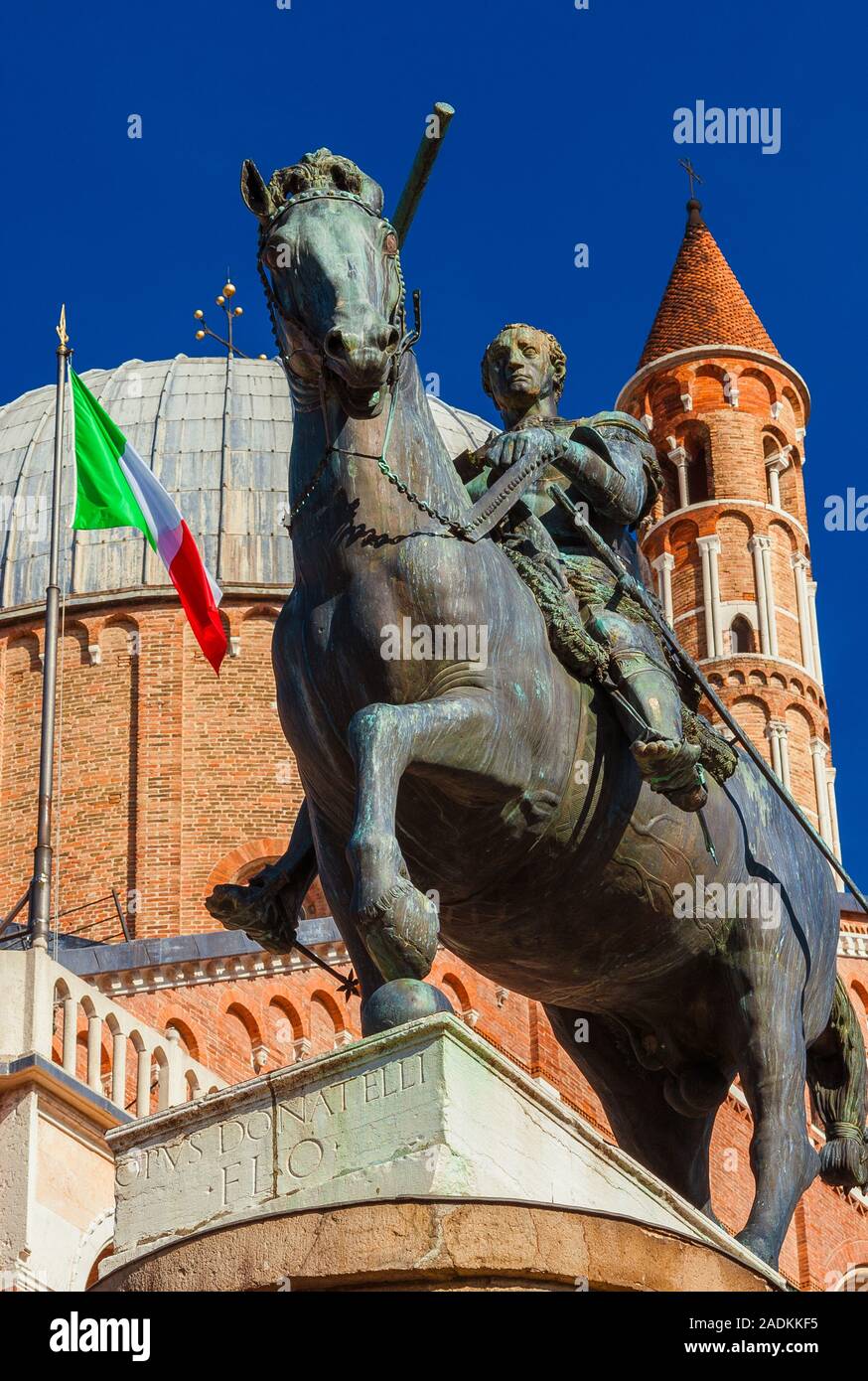 Gattamelata bronze equestrian statue in front of Basilica of Saint Anthony with Italian flag, in the historic center of Padua, erected by the famous r Stock Photo