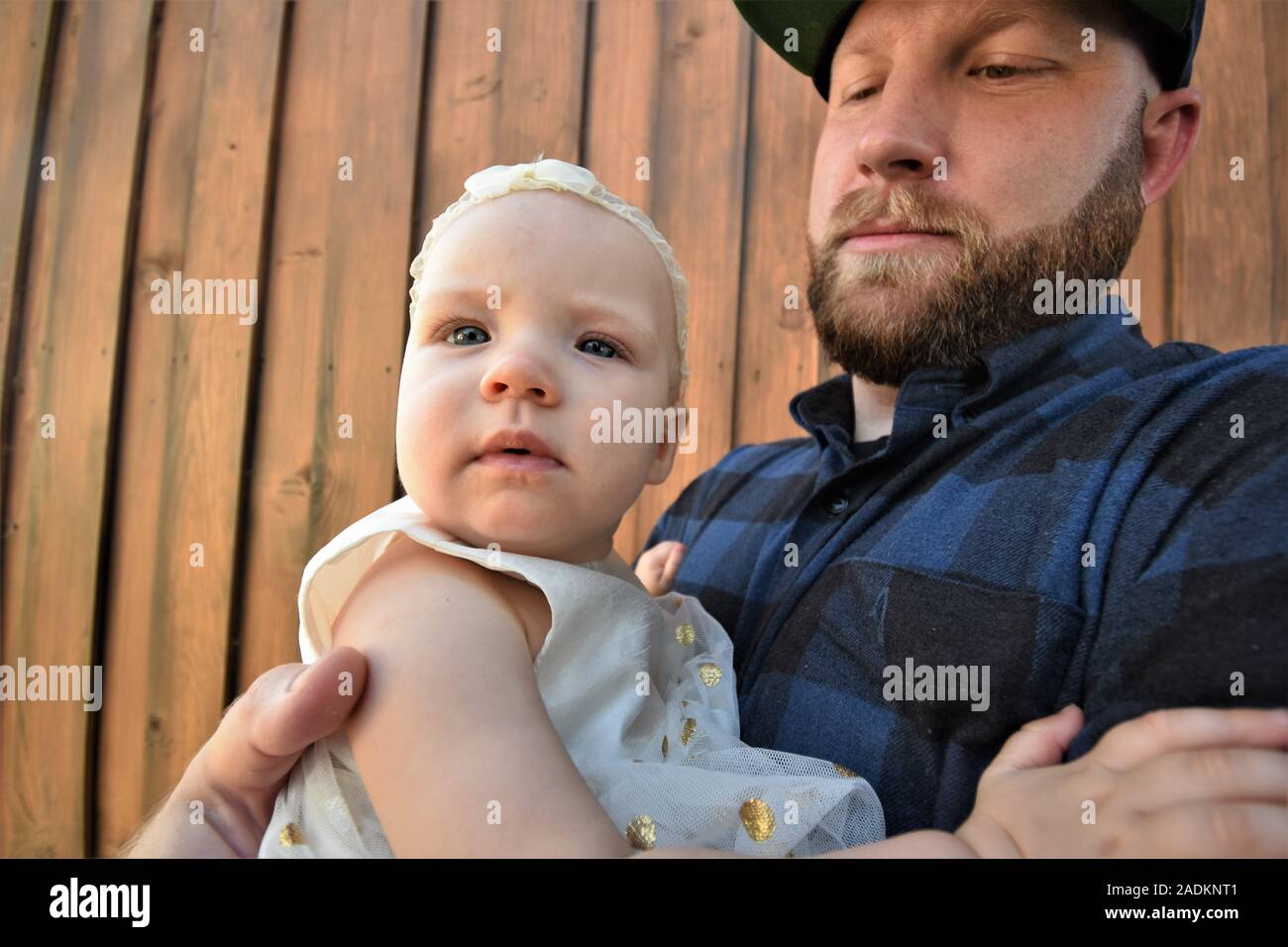 Proud father and daughter at family gathering Stock Photo