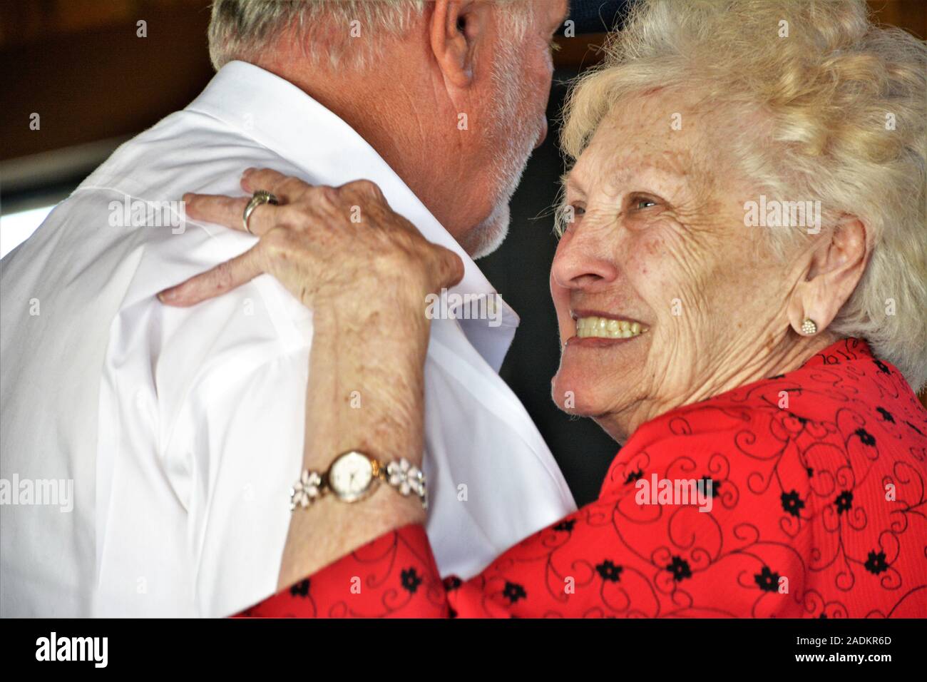 85+ year old mother dancing with her son at a wedding being happy and having a fine time together at granddaughters first wedding in family Stock Photo