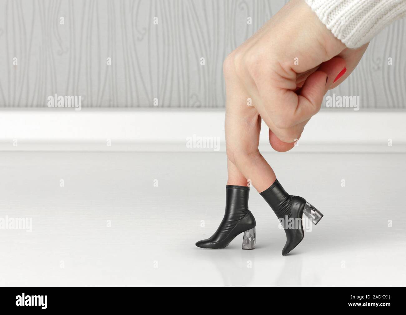Shoes concept. Hand finger dressed with shoe Stock Photo