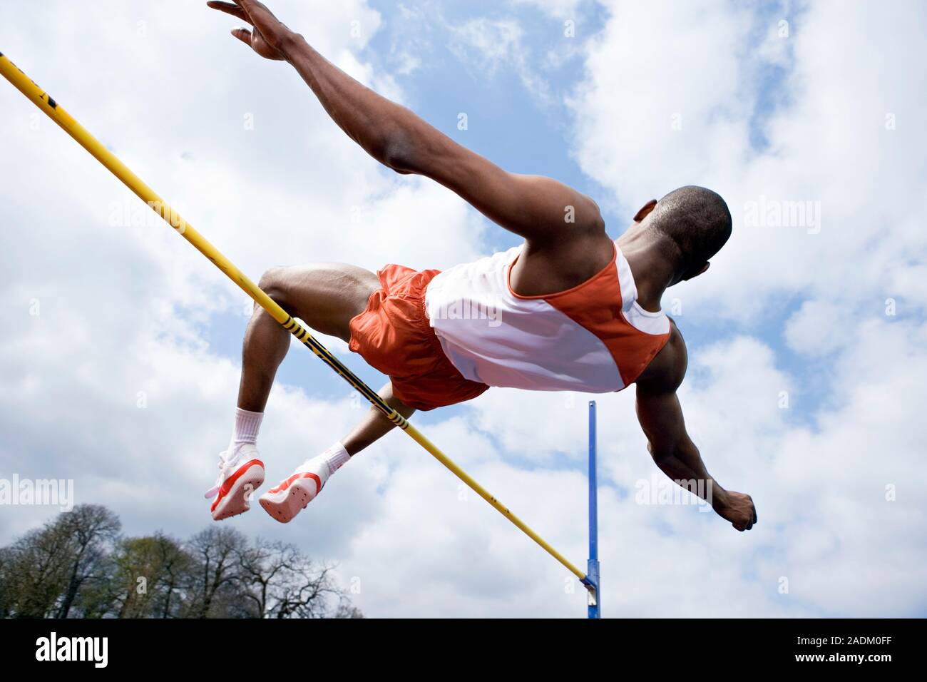 MODEL RELEASED. Athlete performing a high jump. This is a track and ...