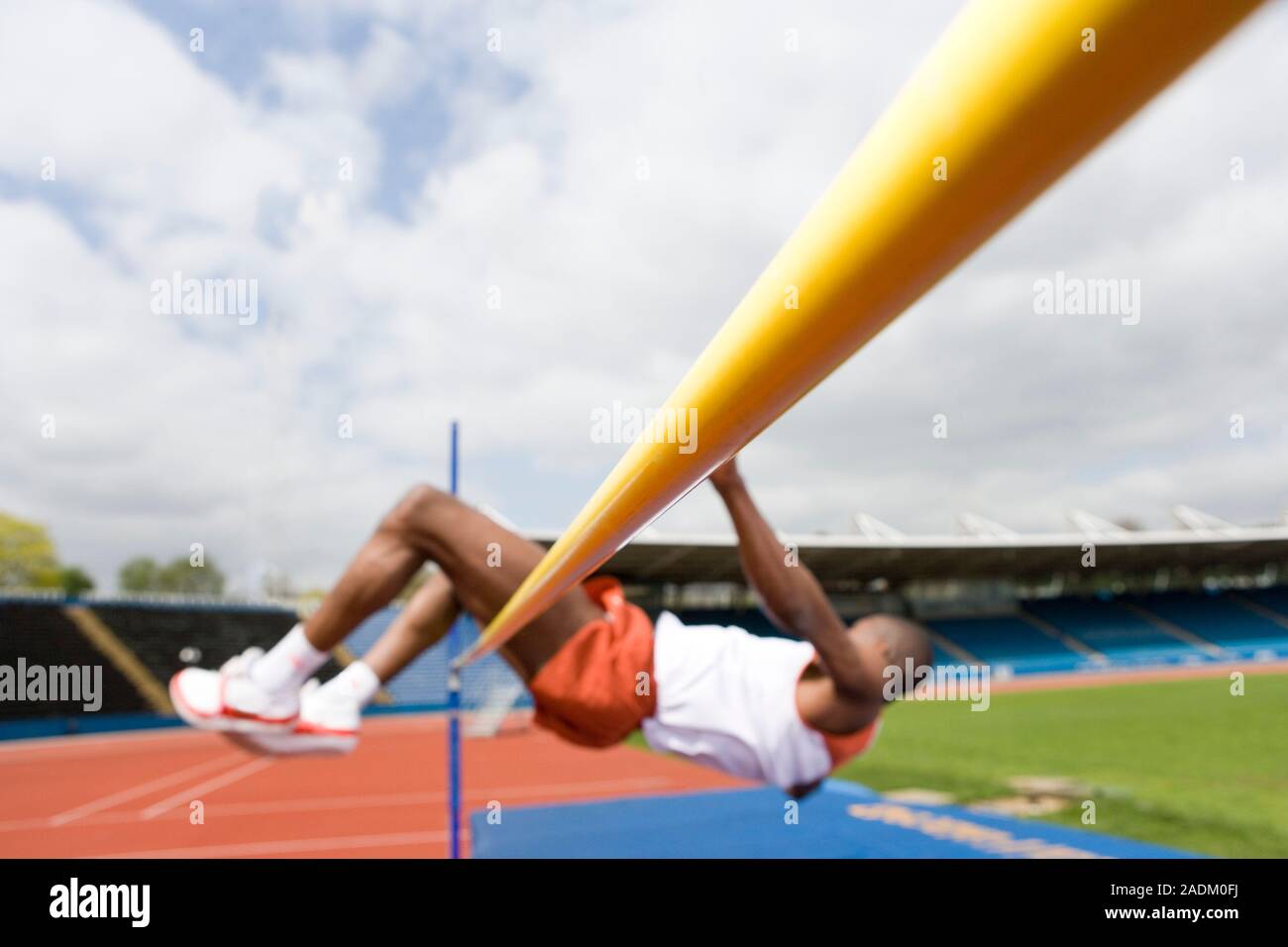 MODEL RELEASED. Athlete performing a high jump. This is a track and ...