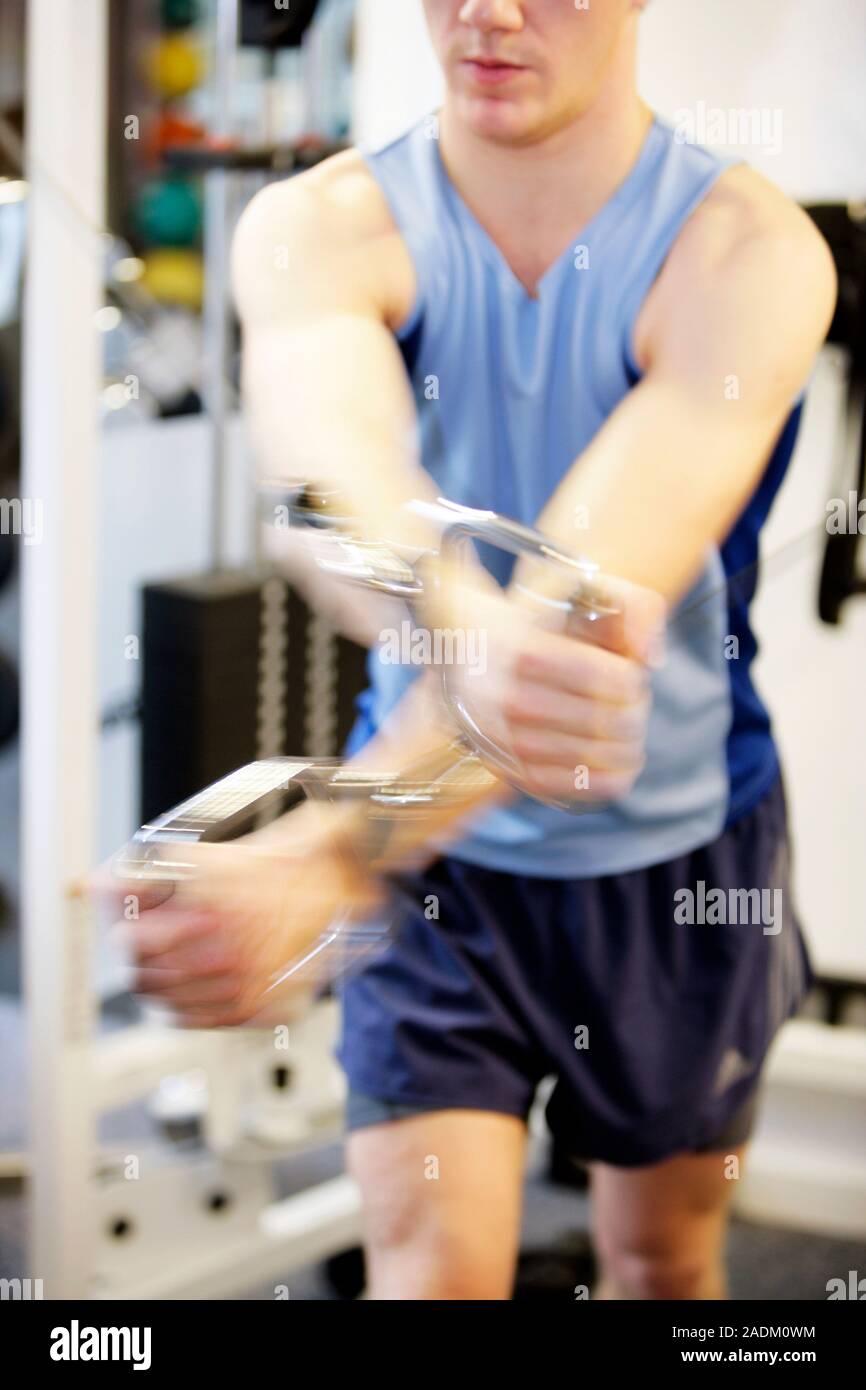 MODEL RELEASED. Strength training. Man using a resistance training