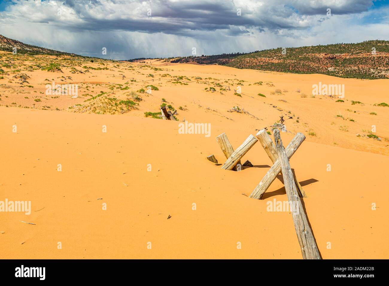 Partially buried split rail fence in Coral Pink Sand Dunes State Park near Kanab, Utah Stock Photo