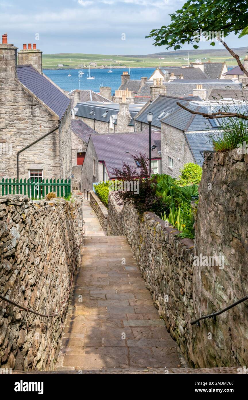 Law Lane is one of the steep lanes leading down to the waterfront at Lerwick.  Island of Bressay in background. Stock Photo