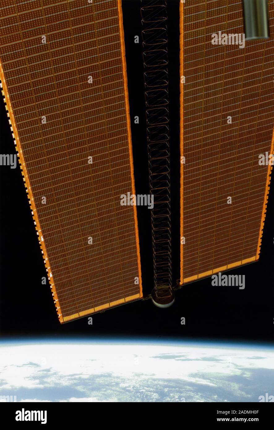International Space Station (ISS) solar panels over a limb of the Earth ...