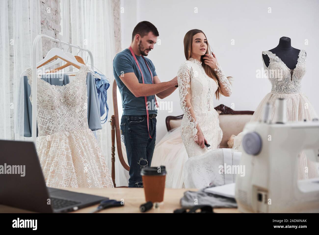 Little help here. The process of fitting the dress in the studio of