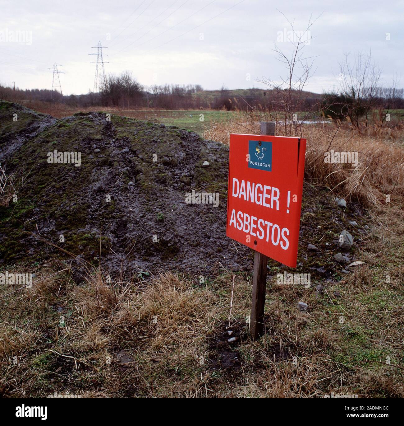 Asbestos warning sign marking land contaminated with asbestos buried