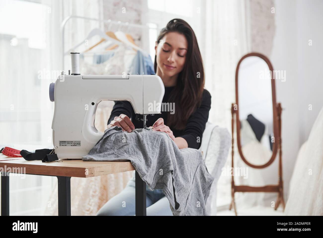 Fully concentrated at her job. Female fashion designer works on the new