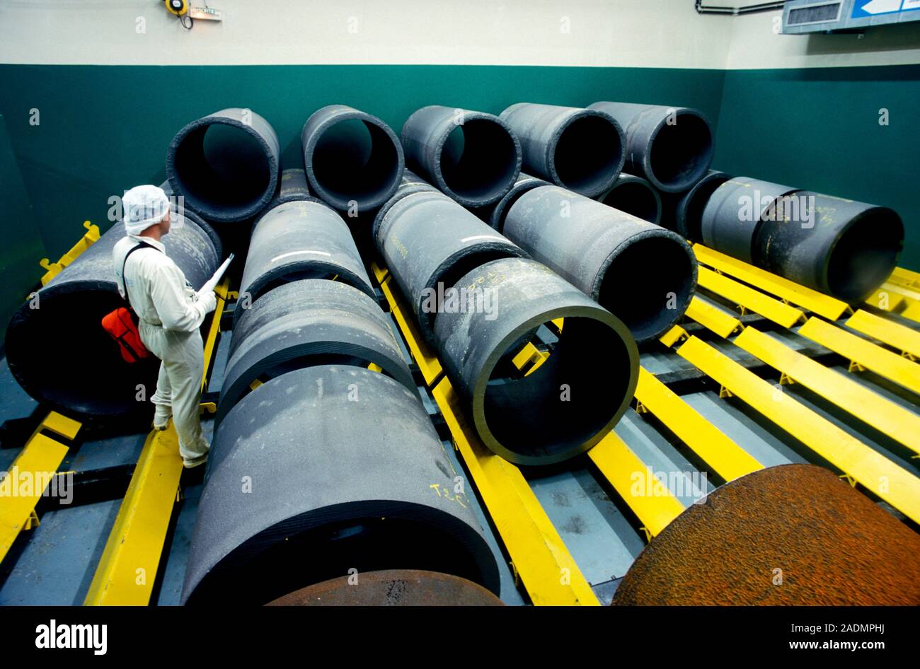 Nuclear waste storage. Worker inspecting concrete shells that will be