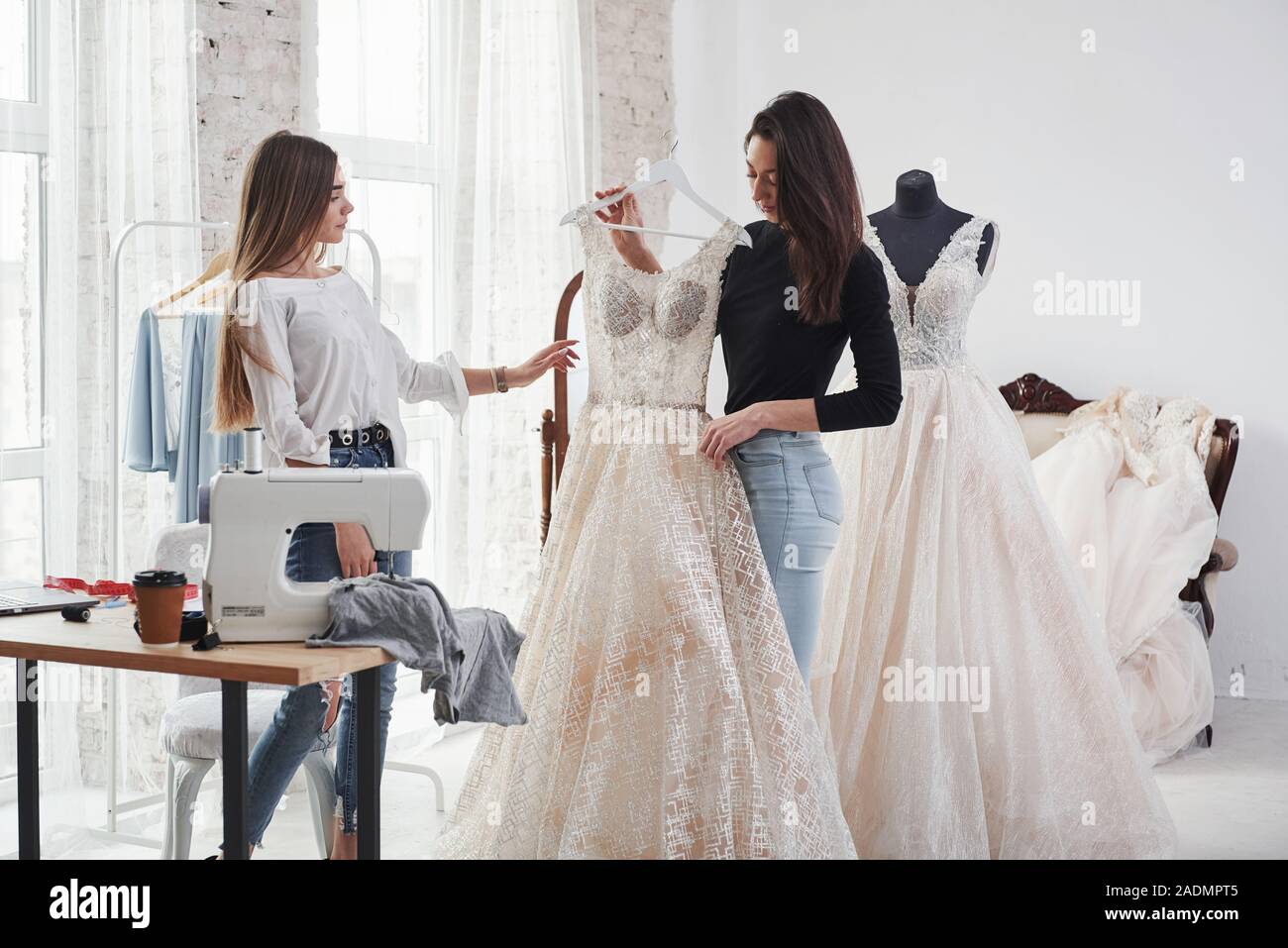 Dress in full height. Two female fashion designers works on the new