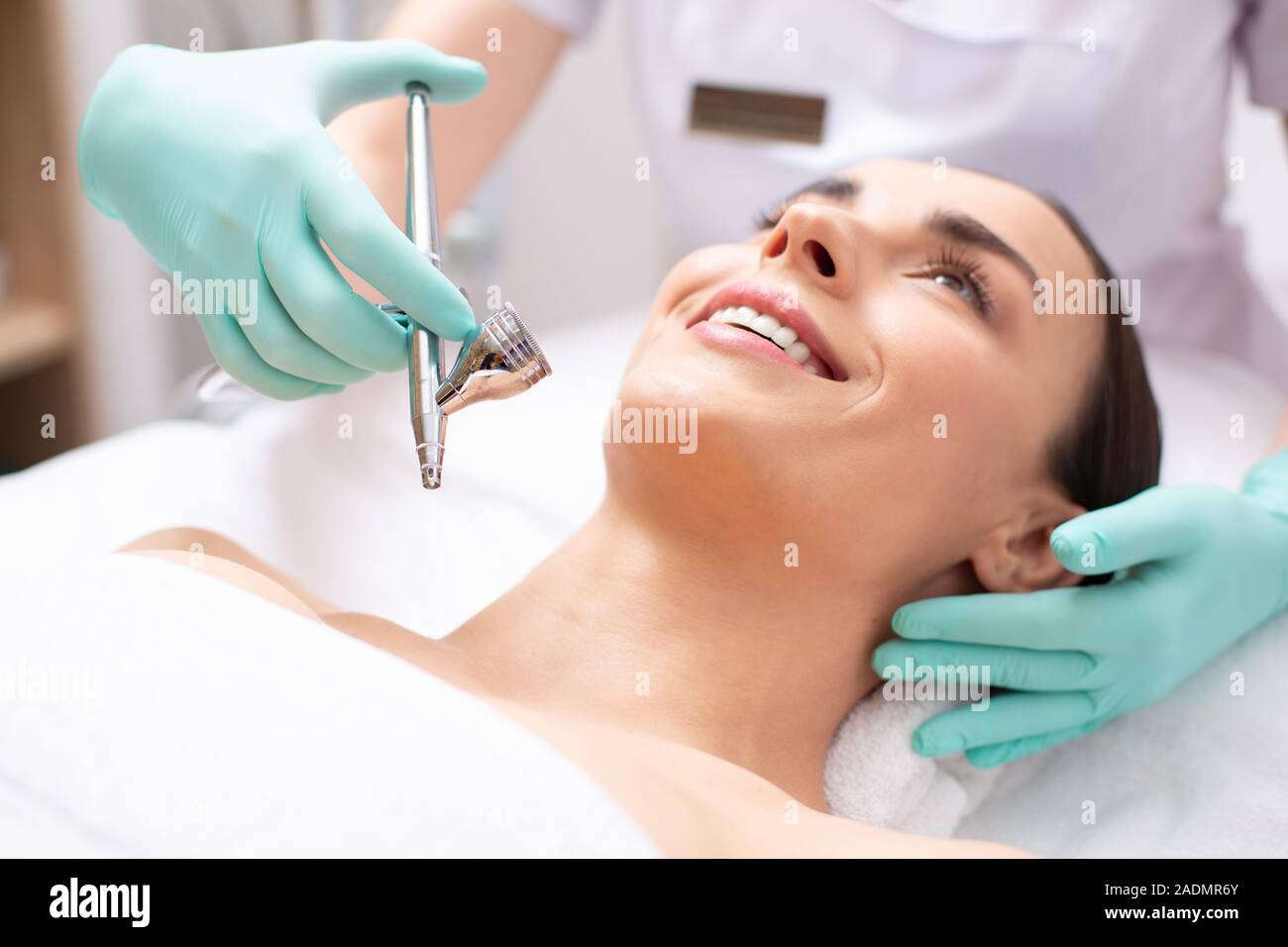 Face of smiling woman and oxygen spray treatment Stock Photo