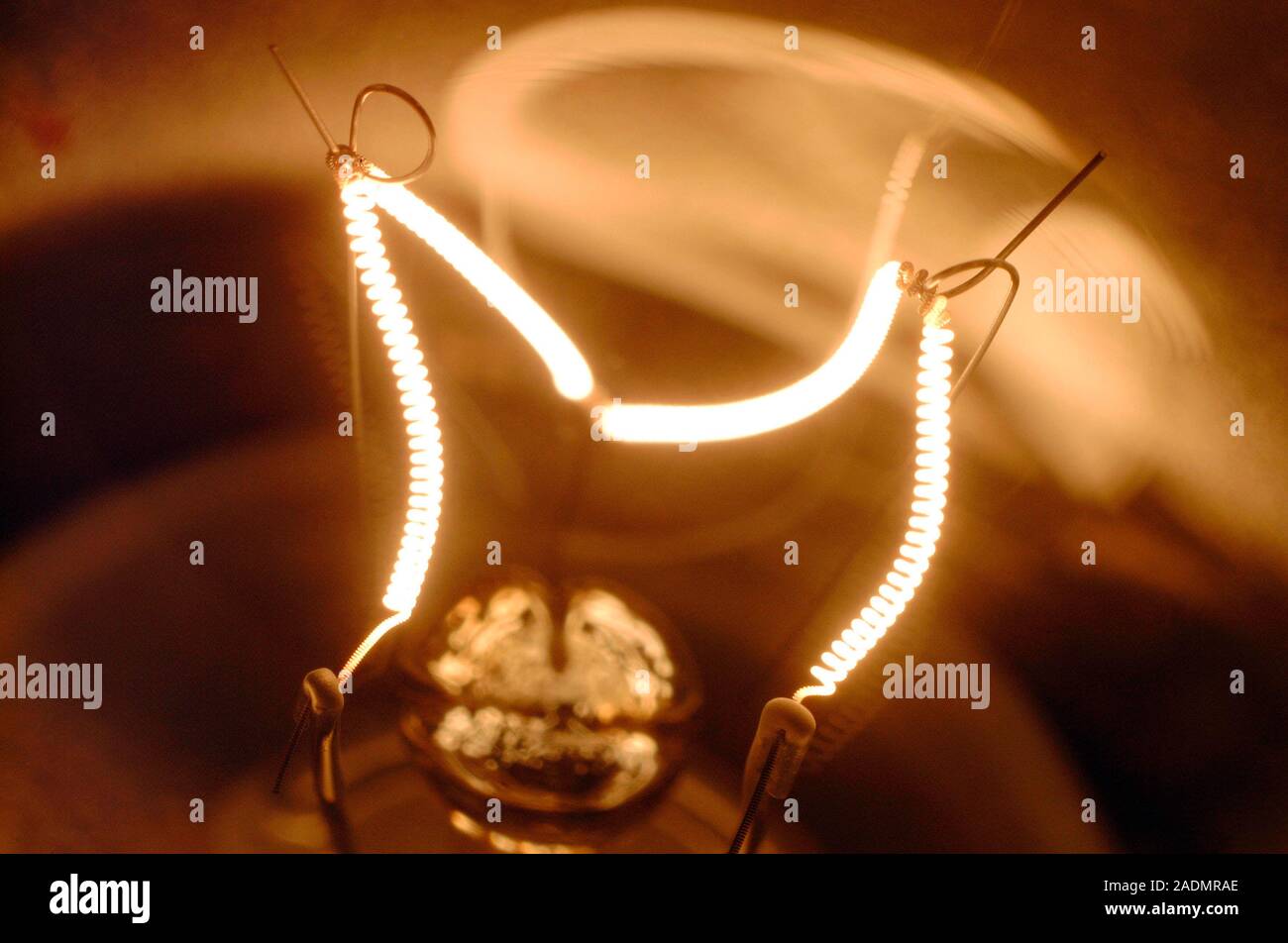 Light bulb filament glowing as it is heated by the electric current