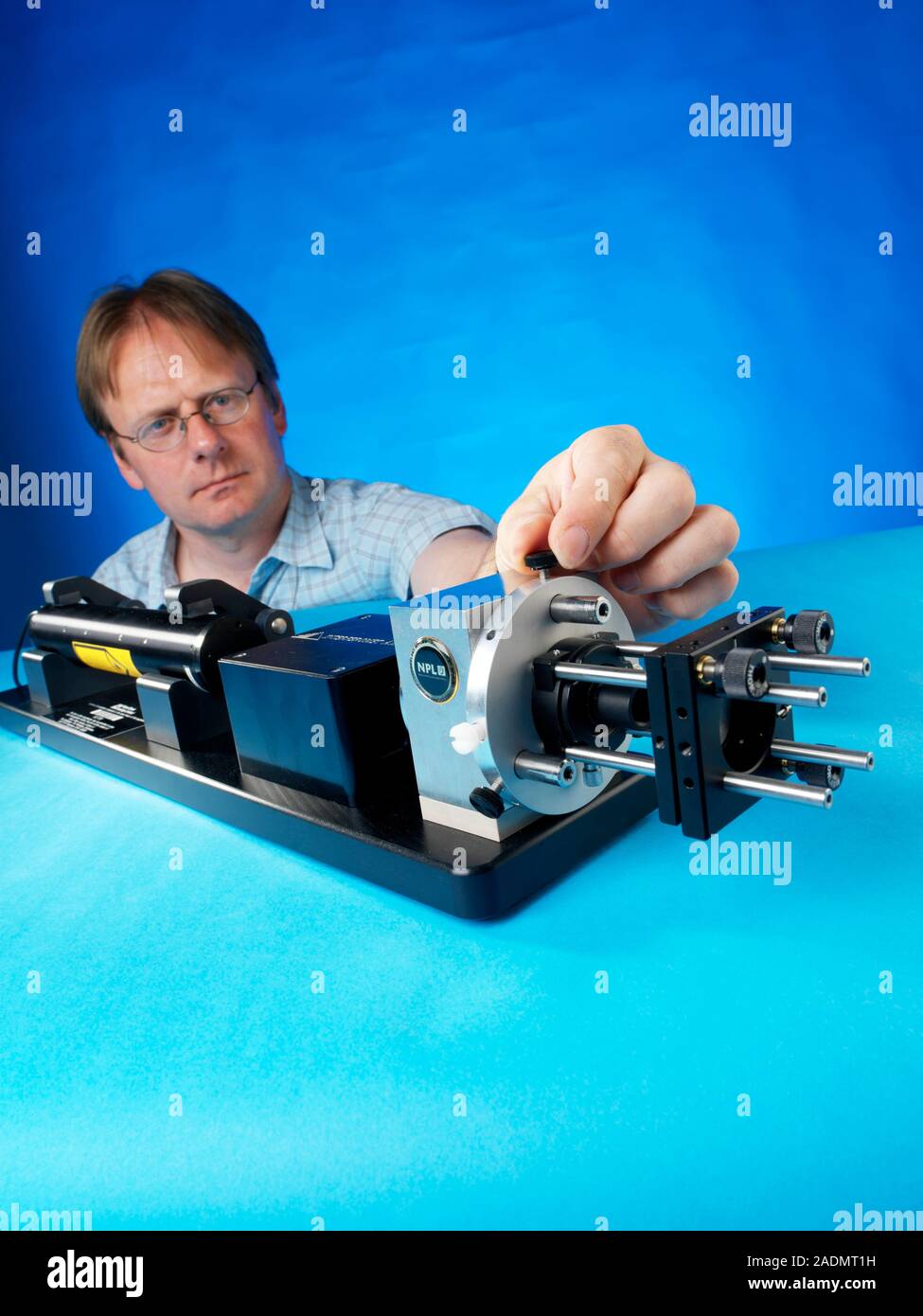 Laser interferometer research. Physicist adjusting a laser