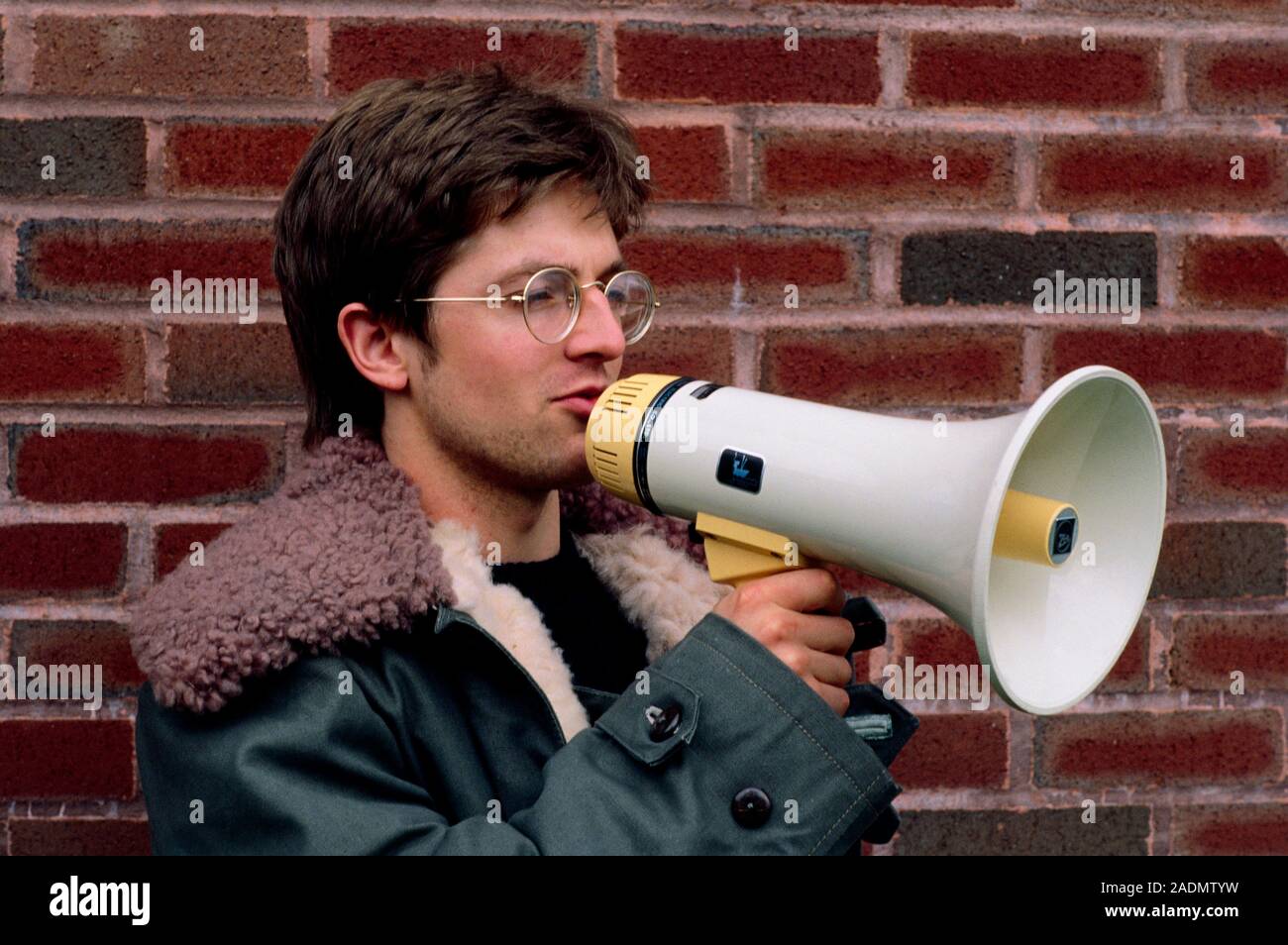 Man using a megaphone, or loud hailer. Stock Photo