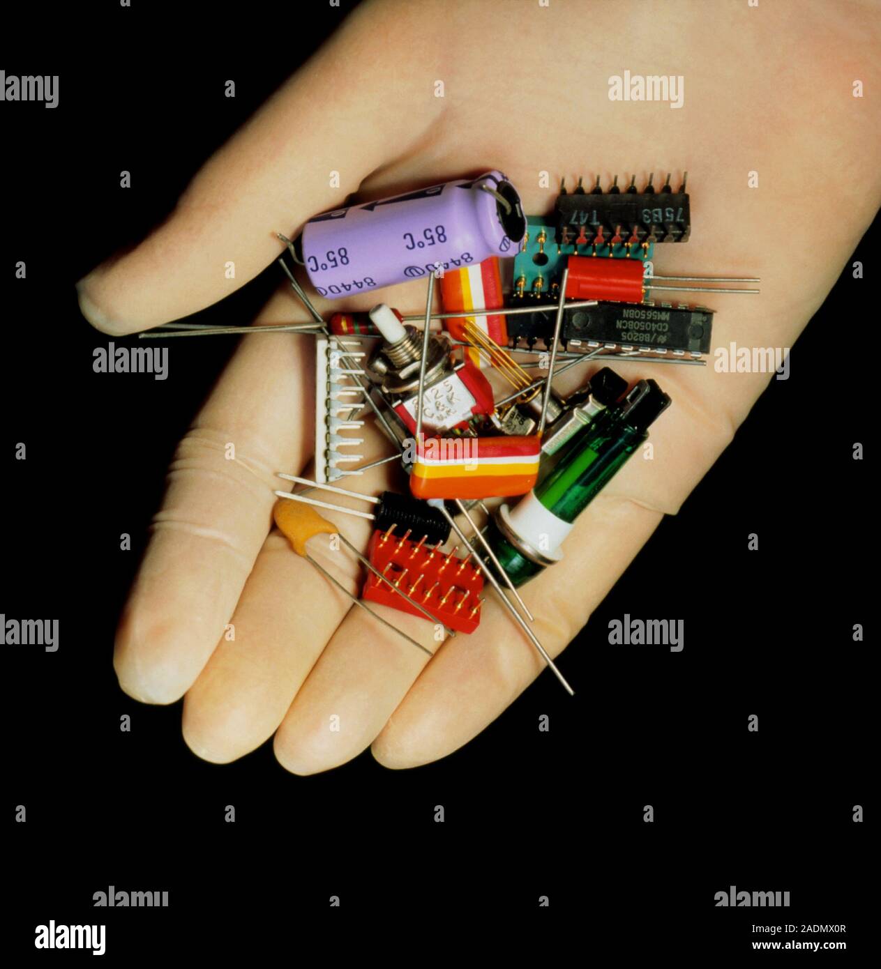 A handful of electronic components, including; resistors, capacitors ...