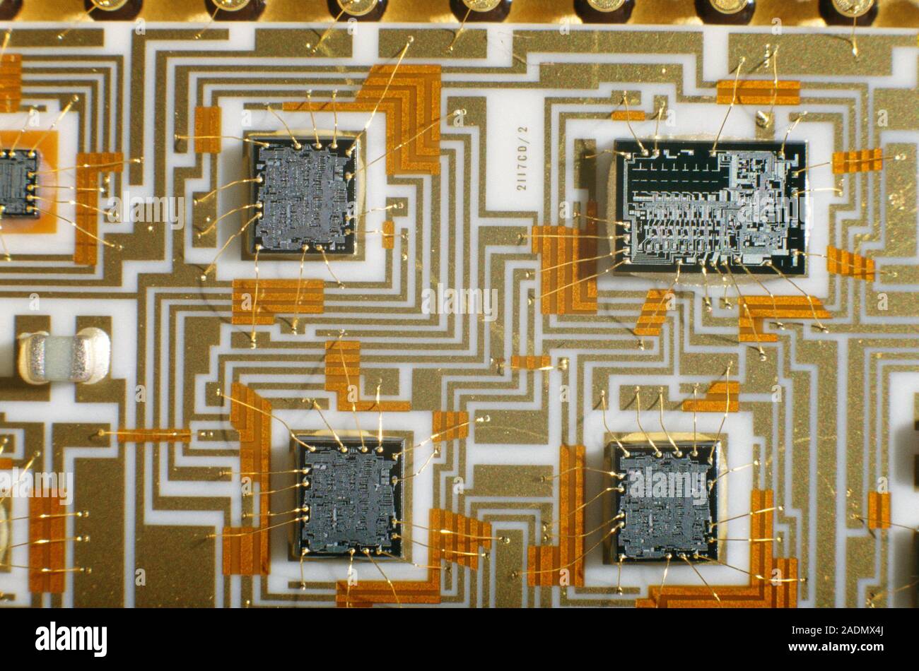 Detail of a finished hybrid electronic circuit, showing four integrated circuits (silicon chips