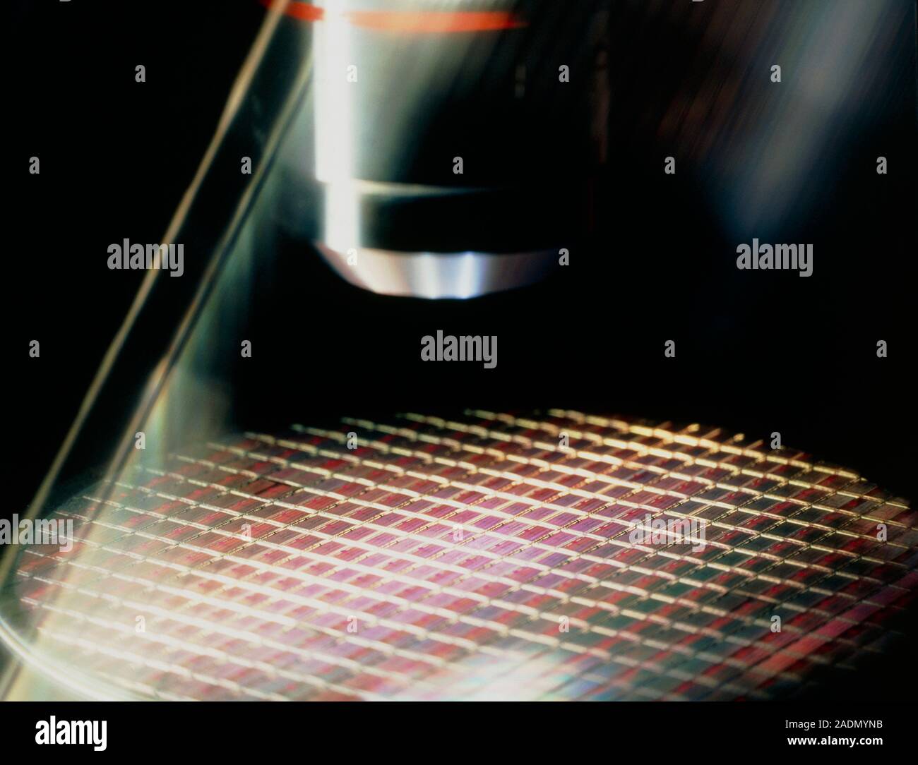 Chip under a microscope. View of a processed silicon wafer under the lens of a microscope for
