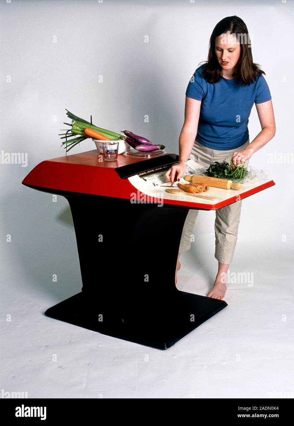 Honeywell Kitchen Computer (H316), with a woman preparing vegetables on it. This was first sold in 1965 for $10,600. The model seen, is the free-stand Stock Photo