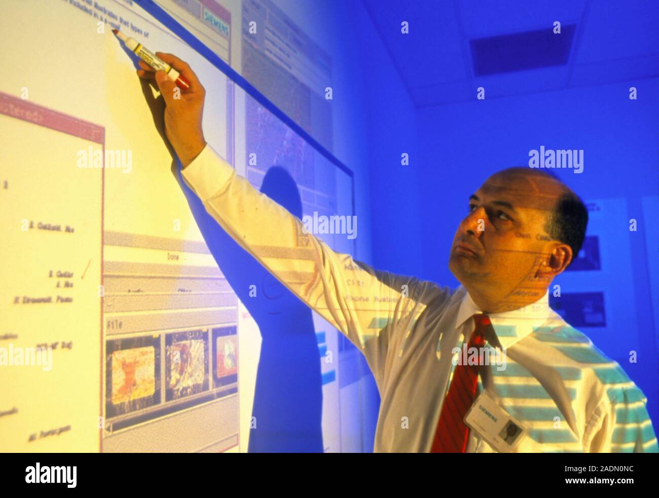 Computer software development. Computer programmer designs computer software. A schematic representation of the program has been projected onto him. T Stock Photo
