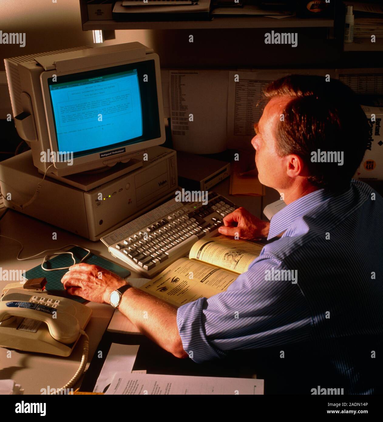 Internet. A man reads the copy- right screen of an internet bulletin ...