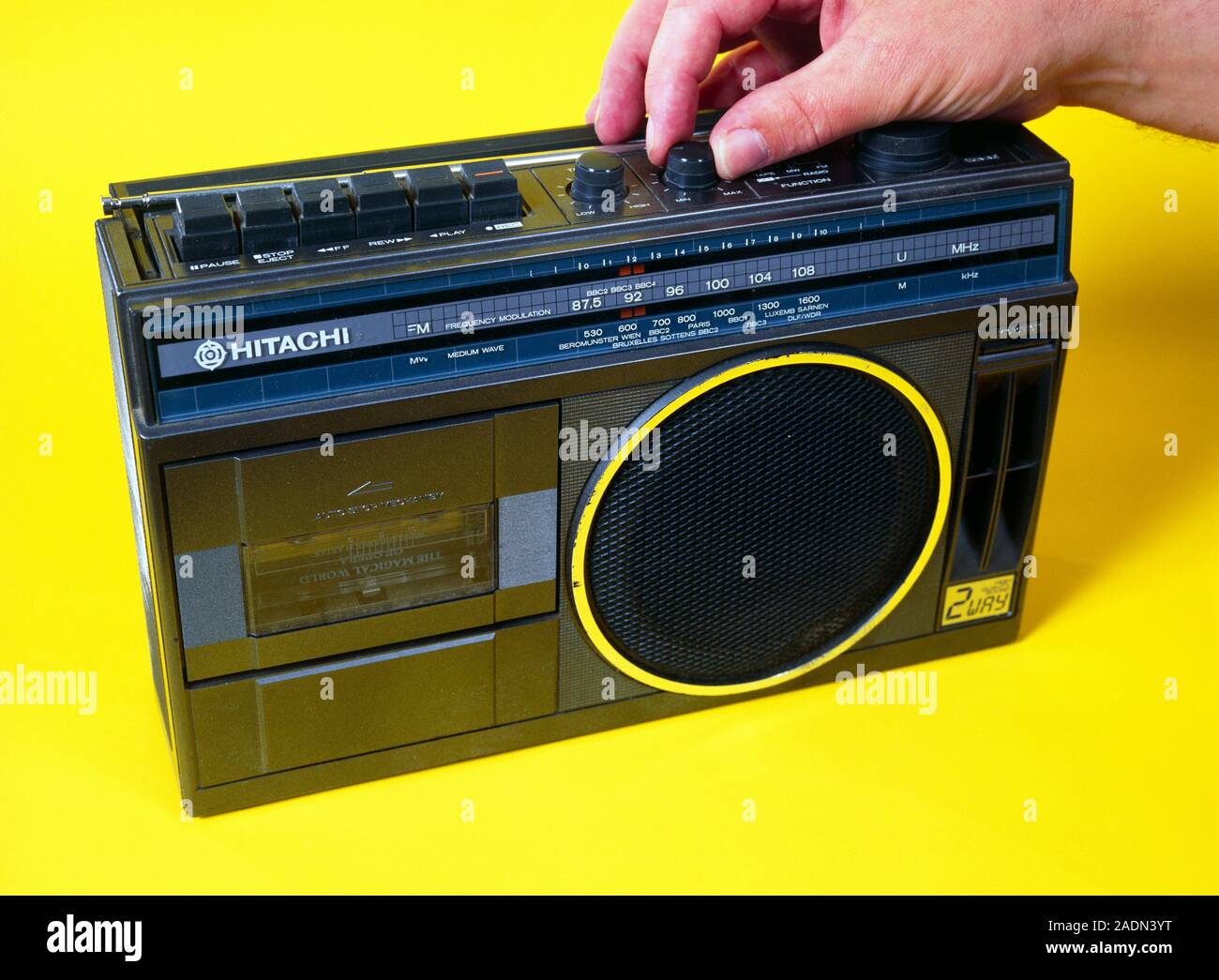 Radio cassette player. Control knob being adjusted on a Hitachi radio