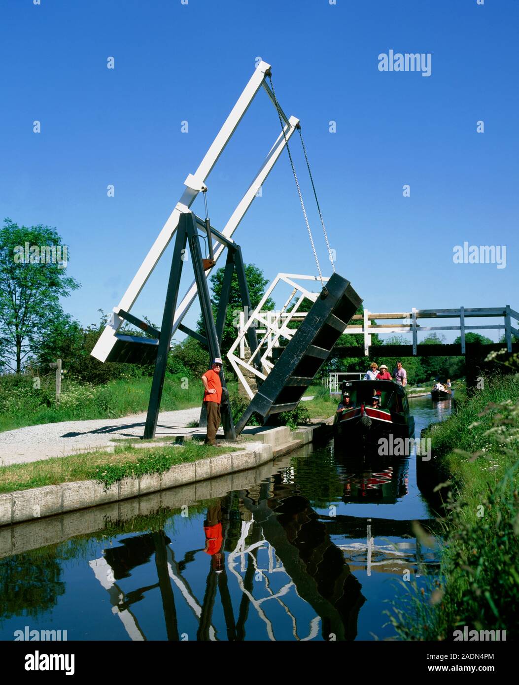 Bridge over canal. View of a barge passing under a manually raised ...