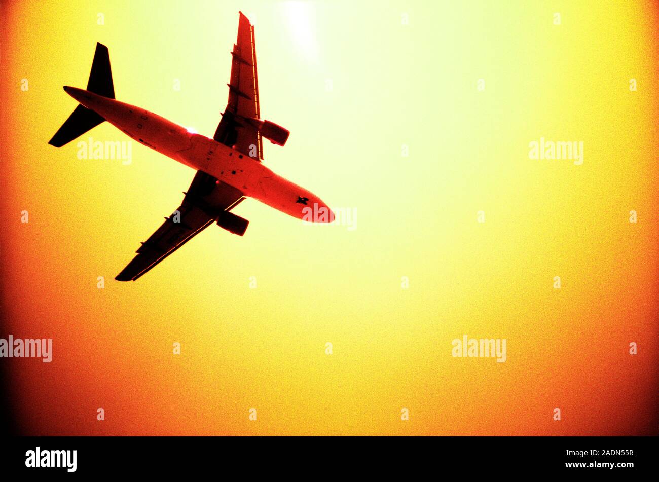 Plane silhouetted against the Sun. Stock Photo