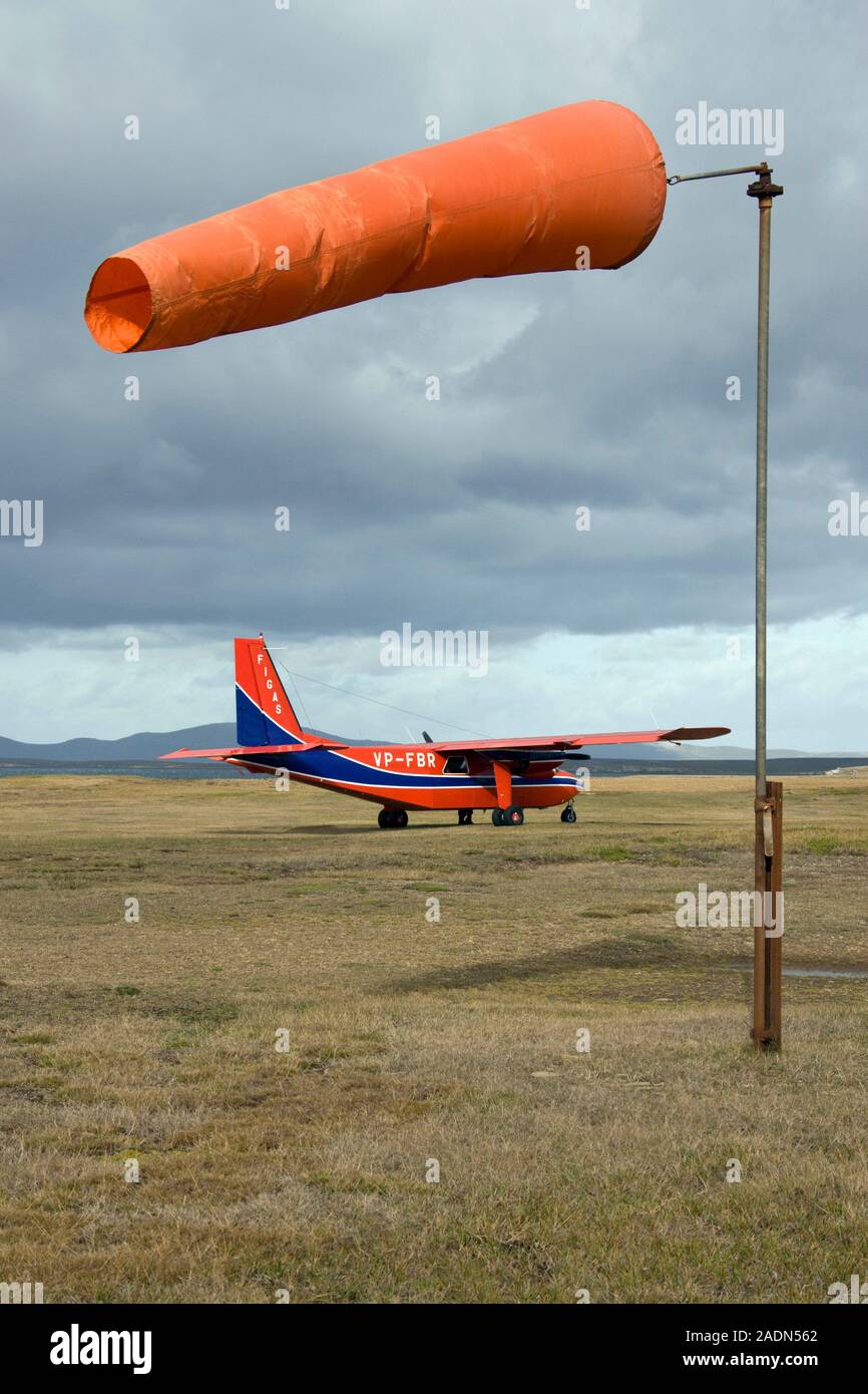 BittenNorman Islander twin engine aircraft and windsock at an airfield on Saunders Island, the