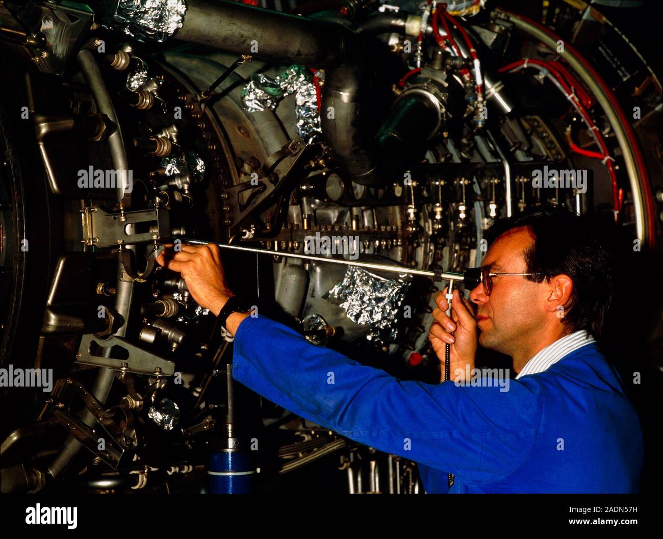 Aircraft engine check. Technician visually inspects the internal