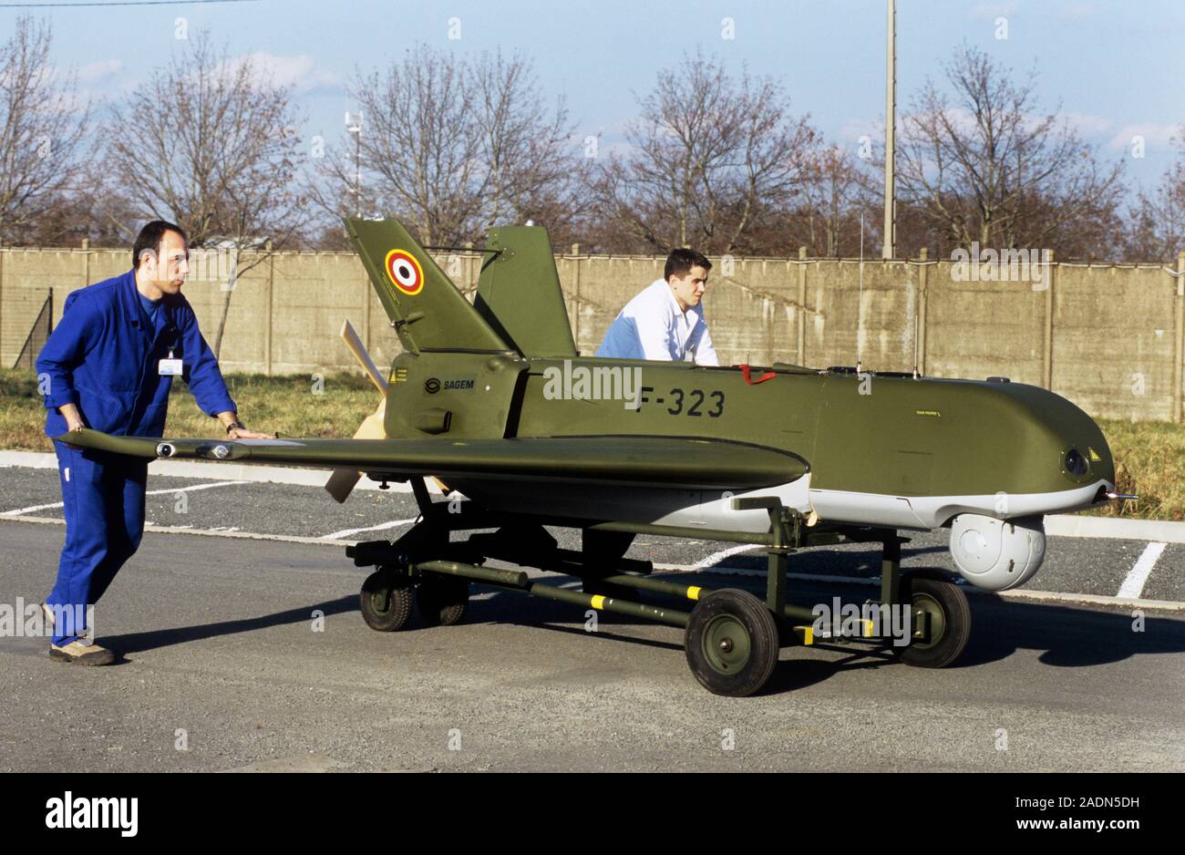 Sperwer UAV tests. Engineers pushing a Sperwer UAV (unmanned aerial vehicle) and its cradle along a road at a manufacturing and testing facility. UAVs Stock Photo