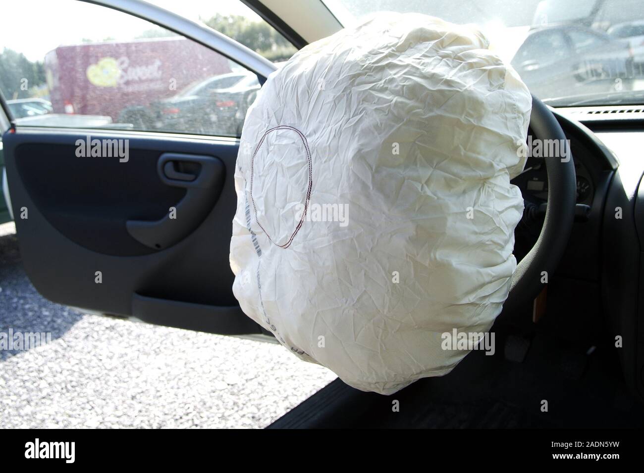 Car airbag inflated on a steering wheel. This device automatically