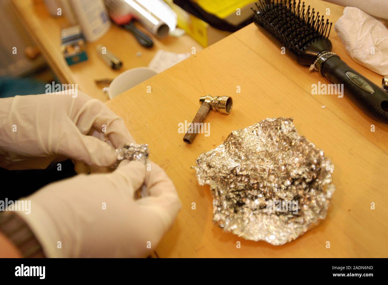 Evidence of drug use. Policeman handling evidence of drug use during a