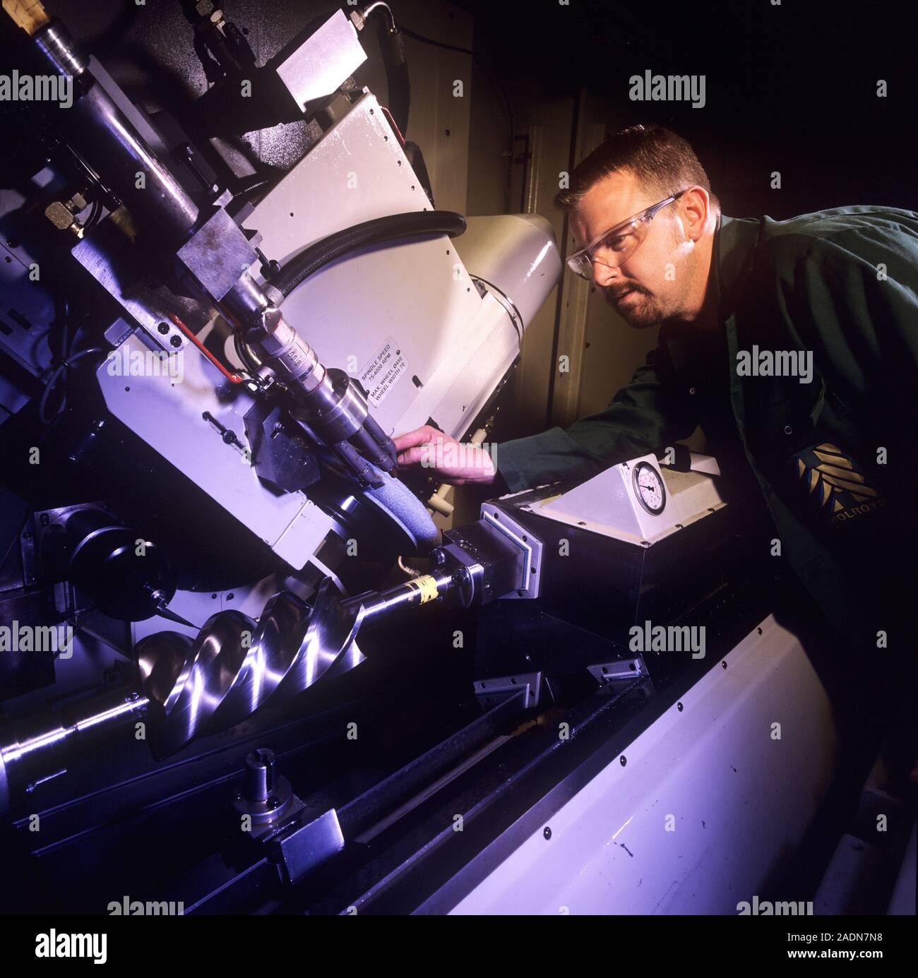 Engineering. Engineer using a thread-grinding machine, a machine ...