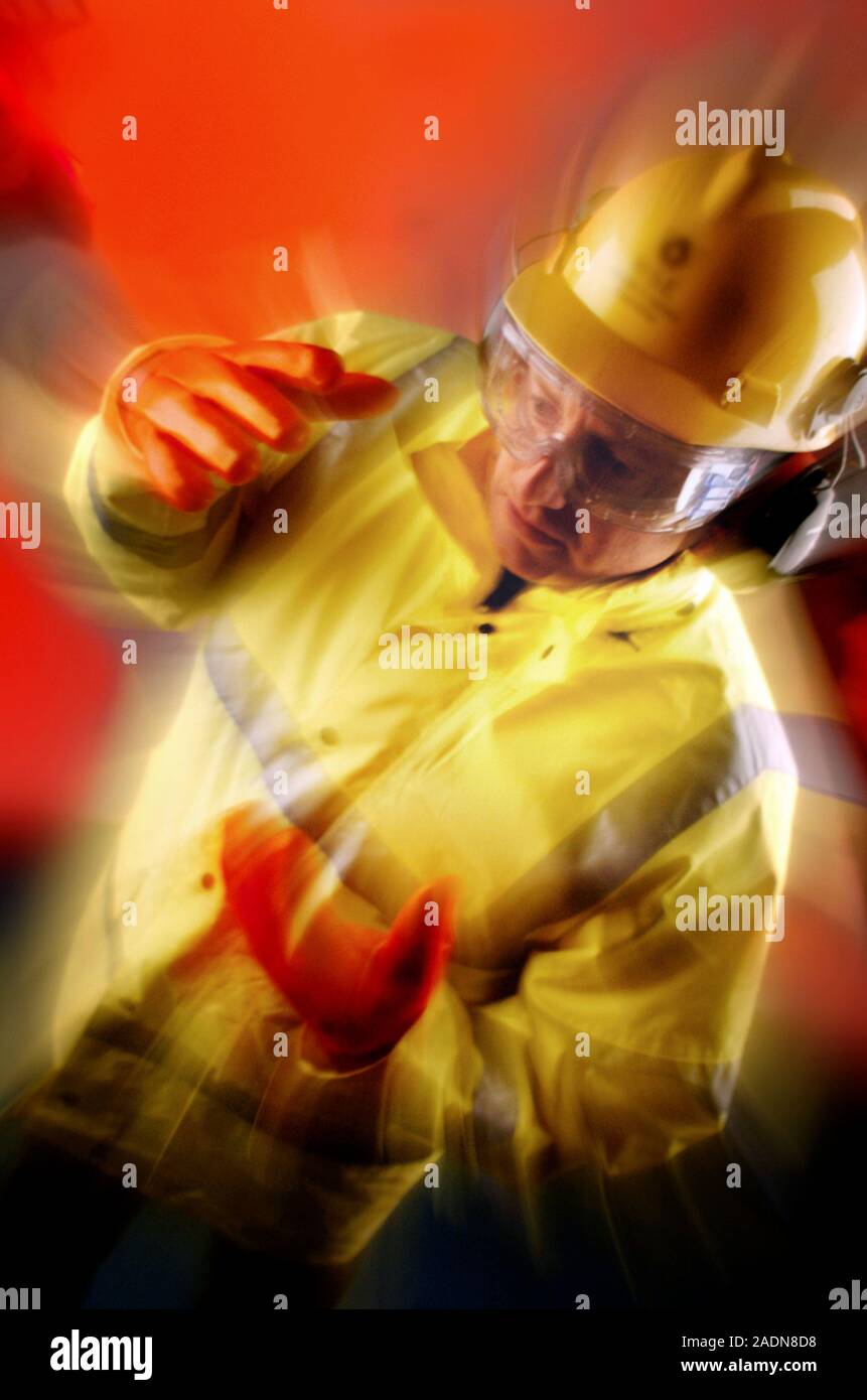MODEL RELEASED. Protective clothing. Man wearing a hard hat, ear ...