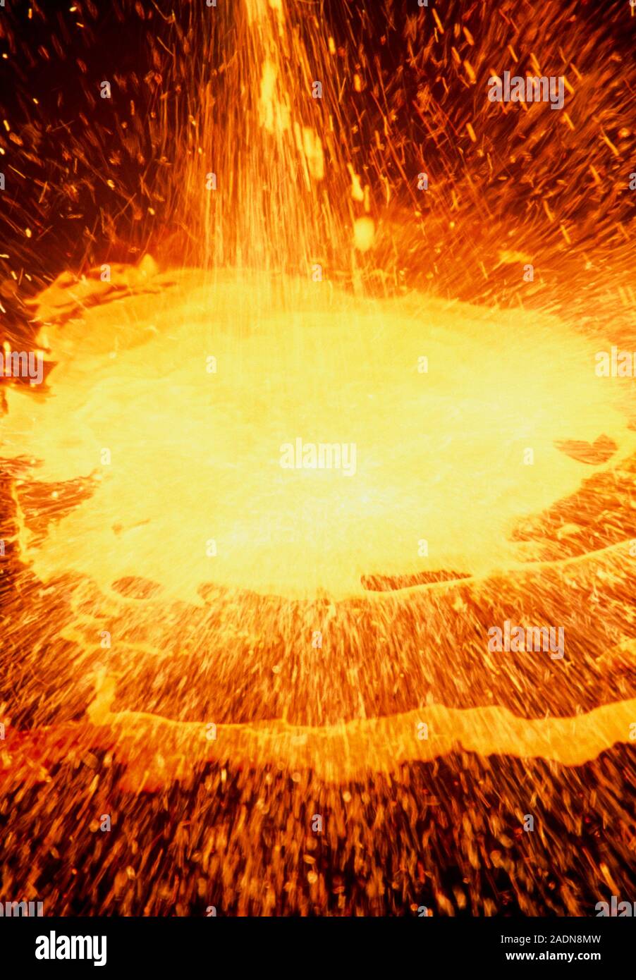 Molten steel. View of a puddle of molten steel which has fallen from a ...