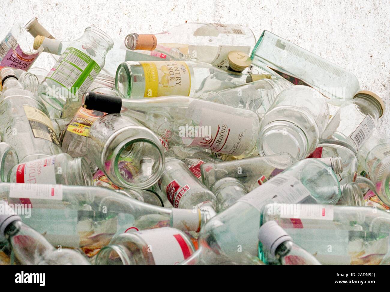 Glass recycling. Empty glass bottles and jars waiting to be recycled at a bottle bank Stock