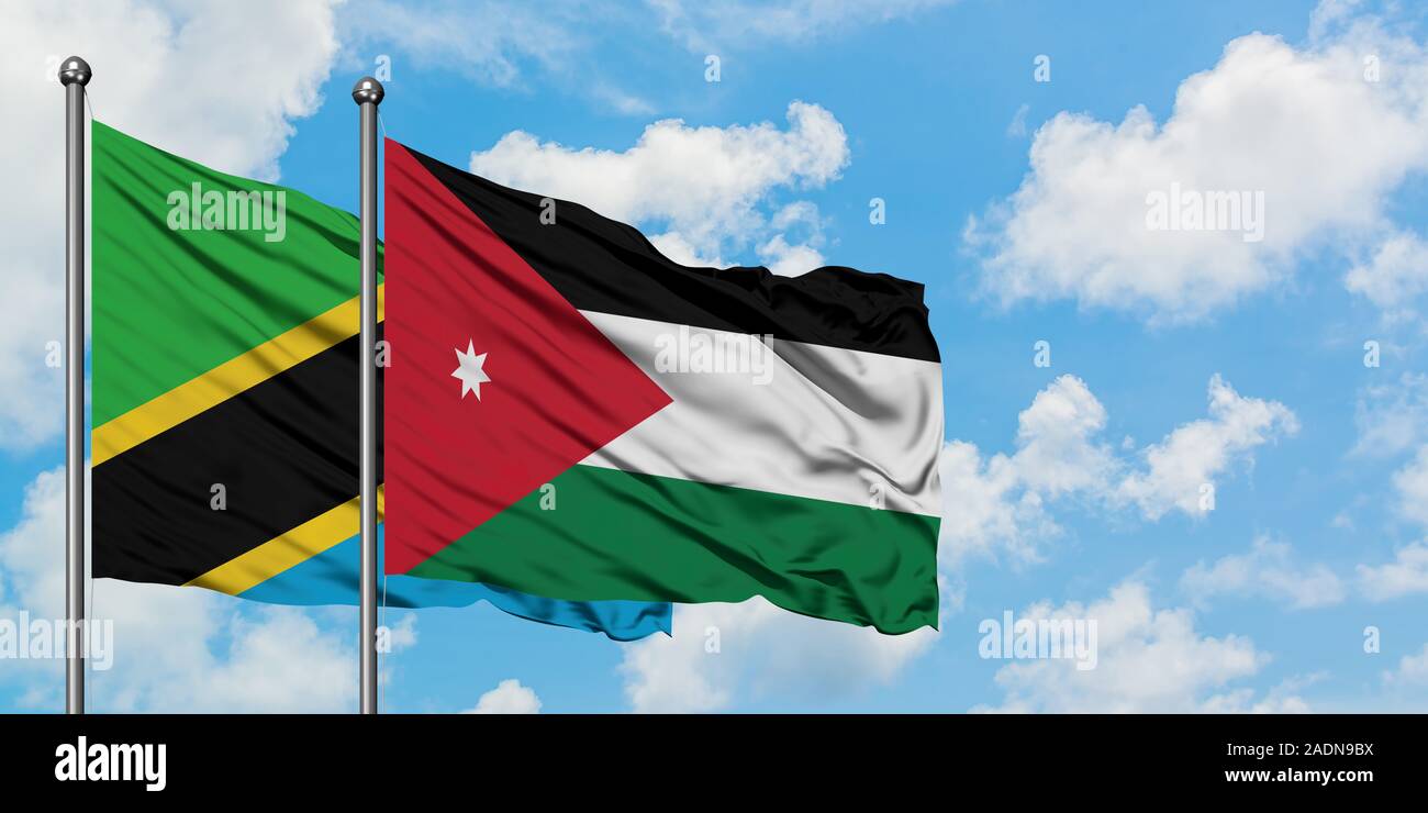 Tanzania and Jordan flag waving in the wind against white cloudy blue sky together. Diplomacy concept, international relations. Stock Photo