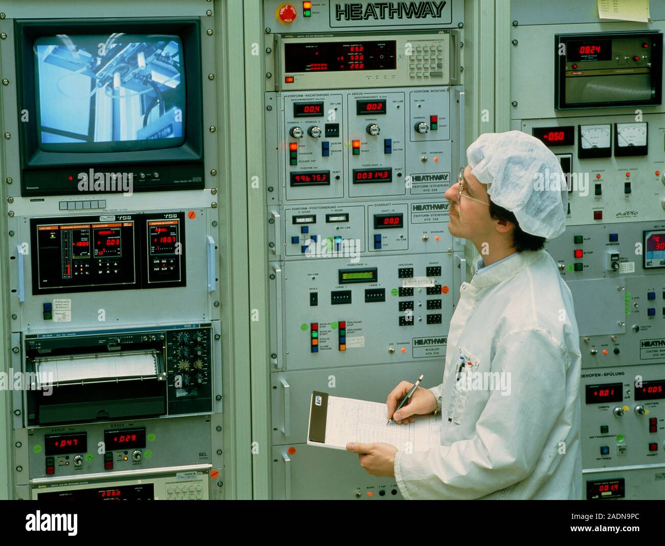 Optical Control Panel Optical fibre manufacture. Techni- cian by a control panel in a glass ...