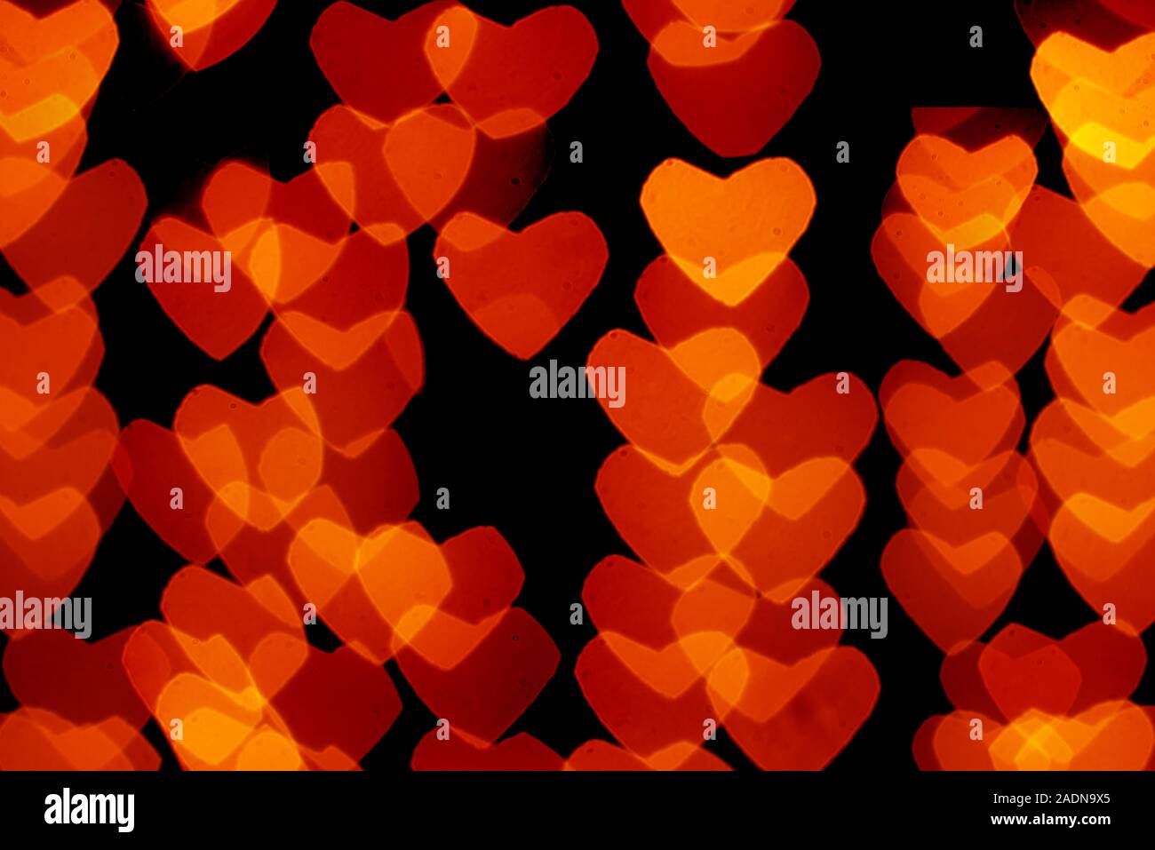 heart shaped orange and yellow bokeh on black background Stock Photo