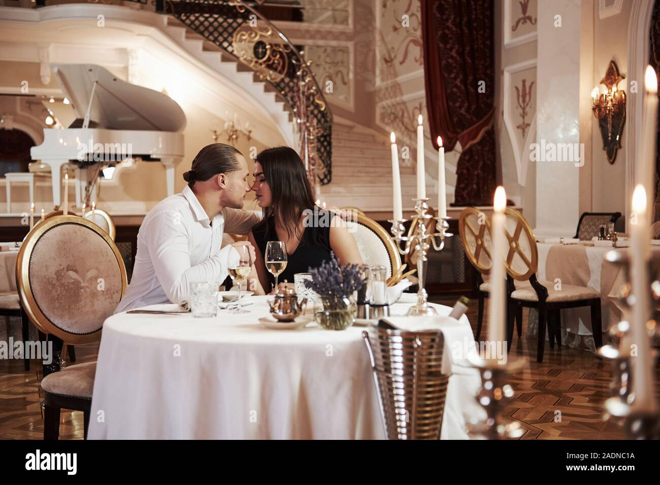 Love is never gets old. Beautiful couple have romantic dinner in luxury restaurant at evening time Stock Photo