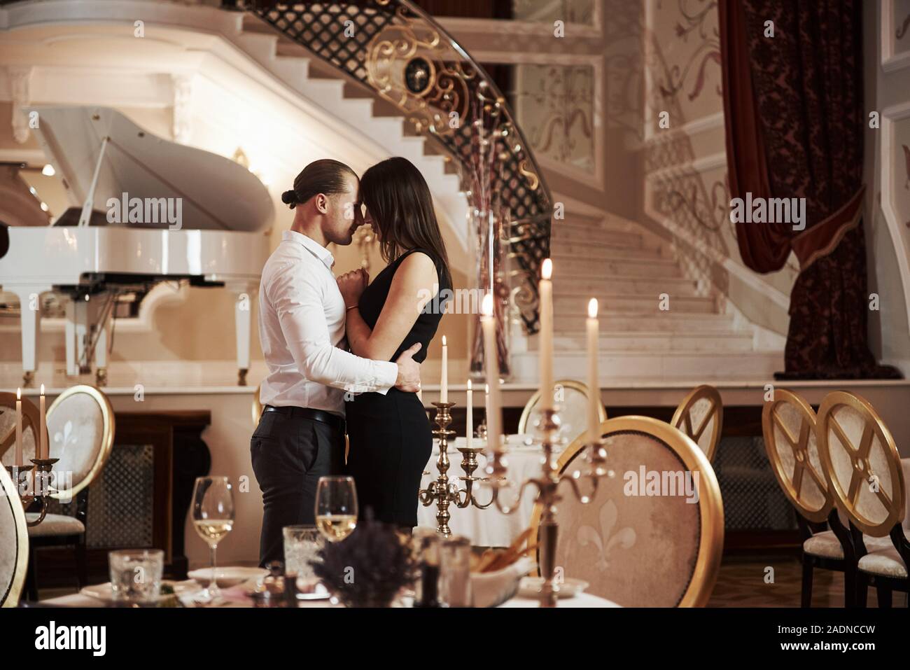 Pure sincere love. Beautiful couple have romantic dinner in luxury restaurant at evening time Stock Photo