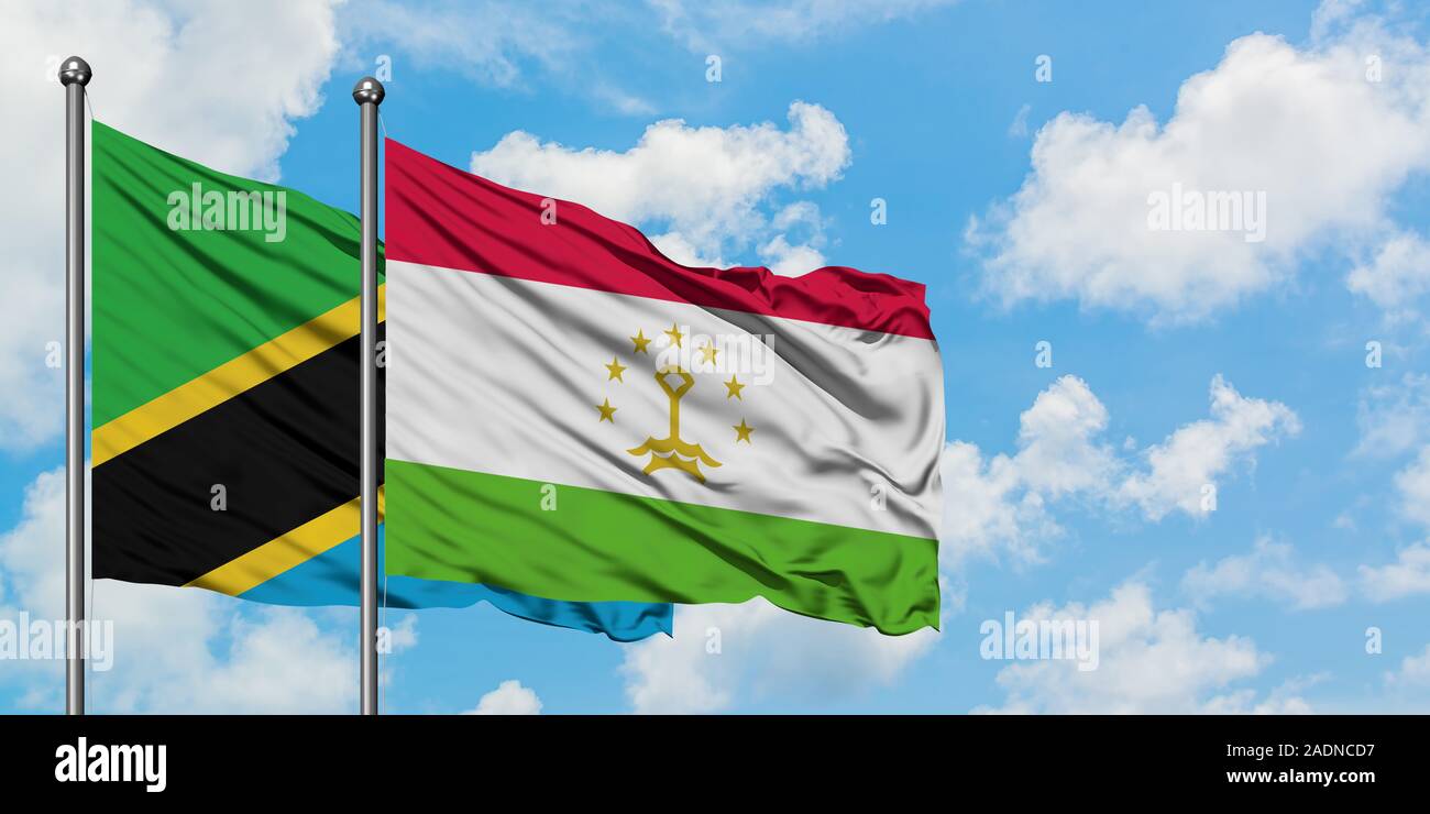 Tanzania and Tajikistan flag waving in the wind against white cloudy blue sky together. Diplomacy concept, international relations. Stock Photo