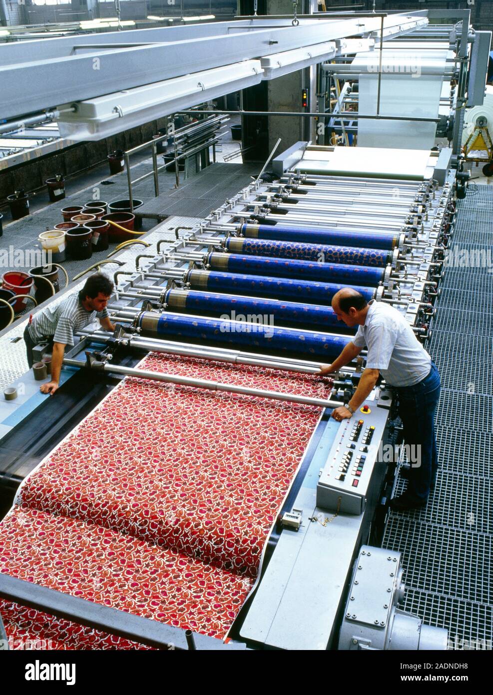 Textile printing. Workers assessing the colours on a textile sheet