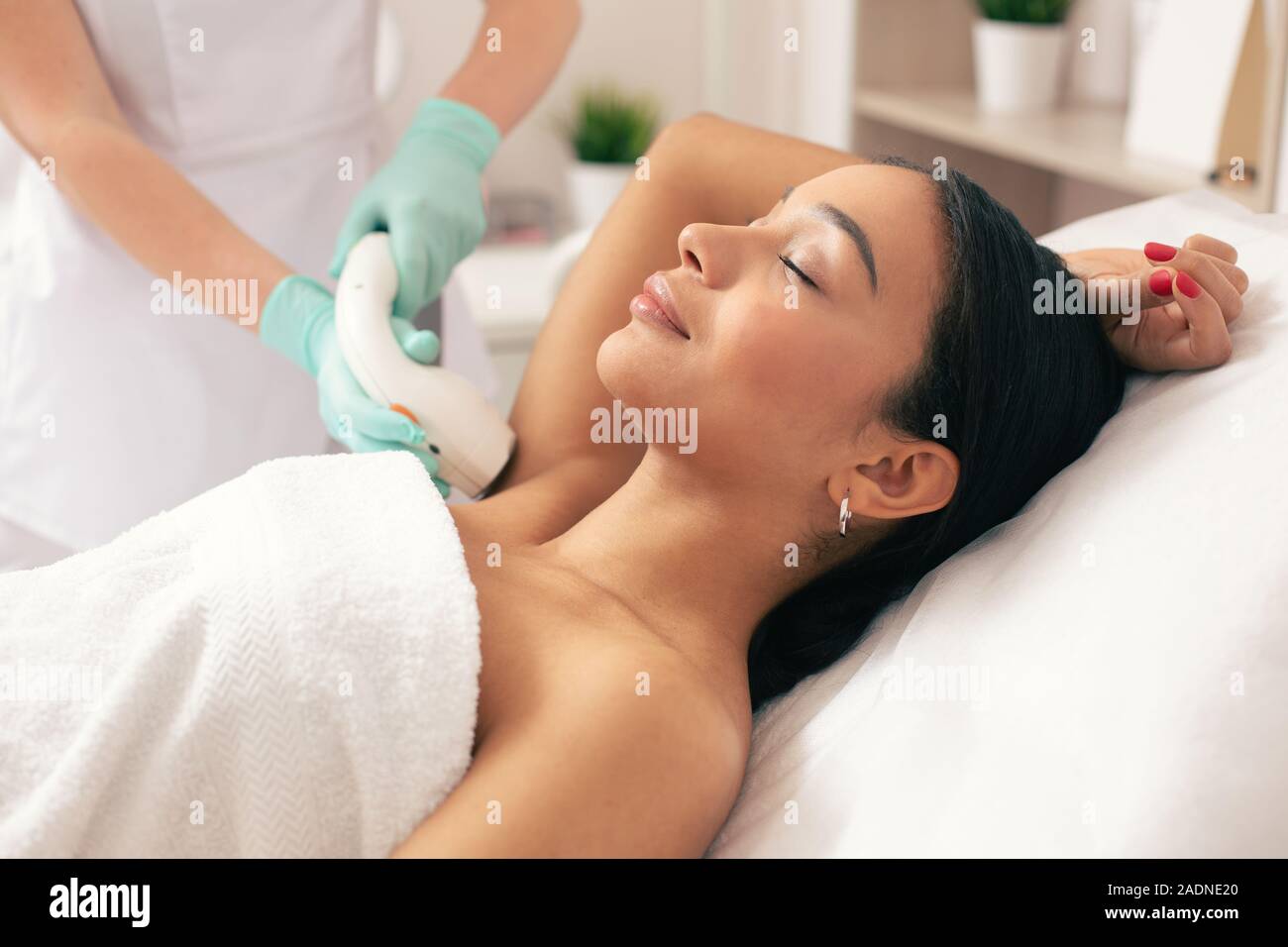 Young Woman Relaxing At The Laser Hair Removal Procedure Stock