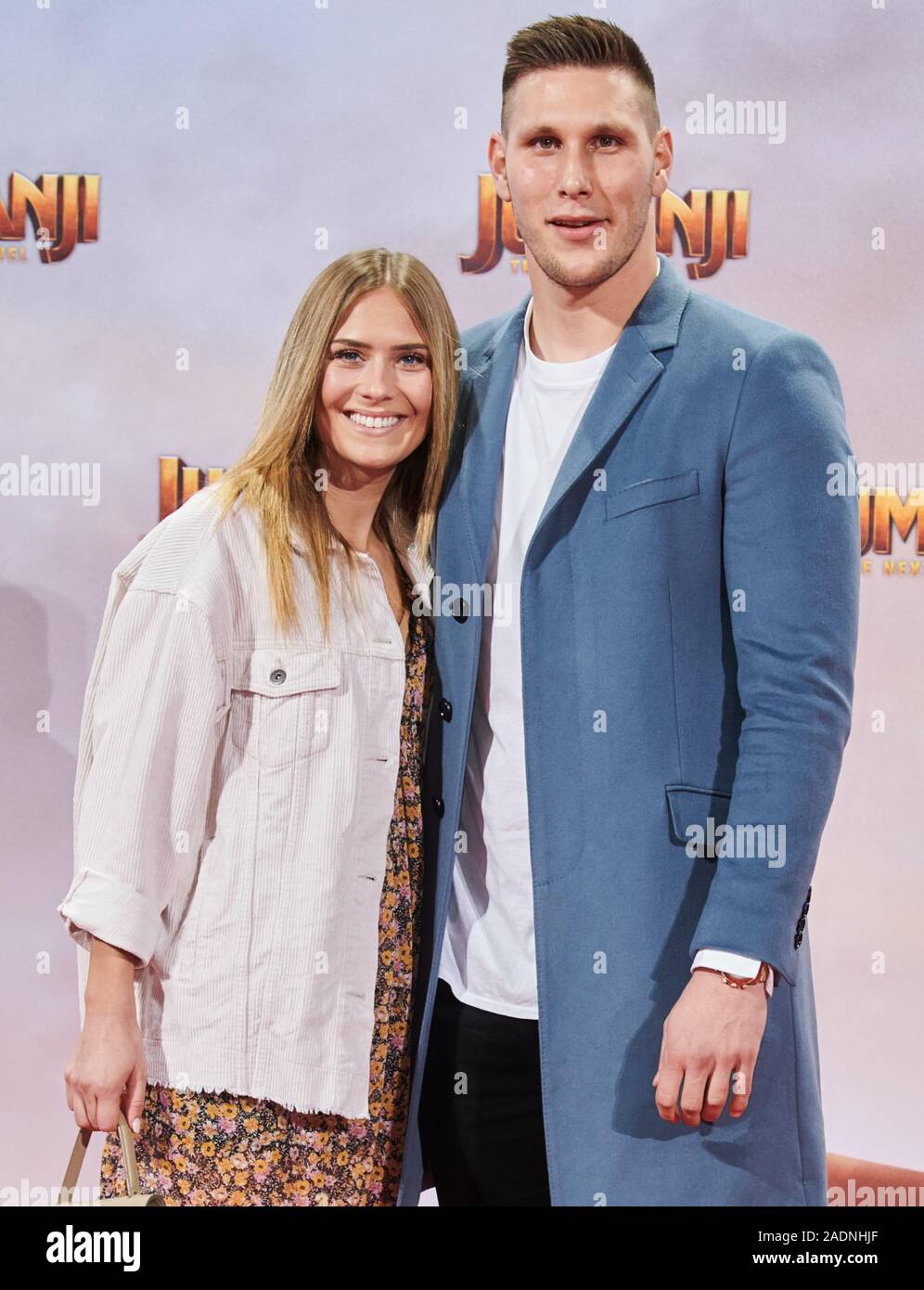 Berlin, Germany. 04th Dec, 2019. Professional soccer player Niklas Süle  from Bayern Munich comes with his girlfriend Melissa Halter to the German  premiere of the film "Jumanji: The next Level". Cinema release