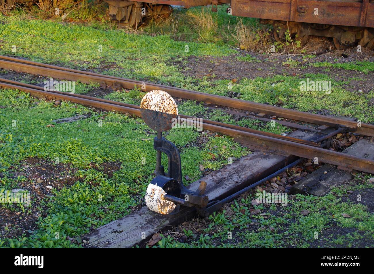 Old railway switch. Rusty handle reversing the train direction. Stock Photo