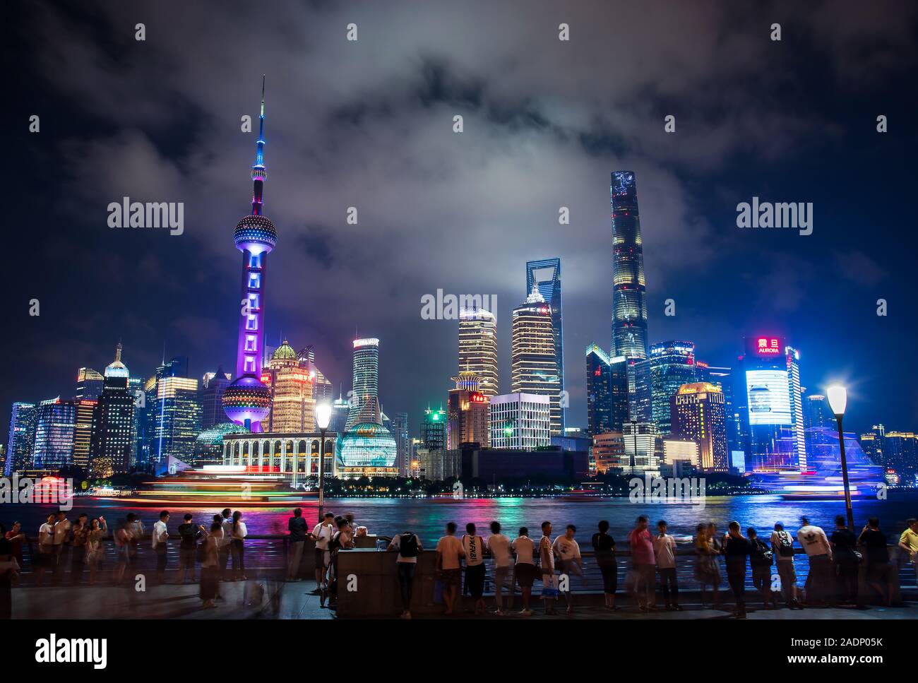Shanghai, China - August 7, 2019: Busy Shanghai downtown with tourists enjoying the skyline with amazing skyscrapers at night Stock Photo